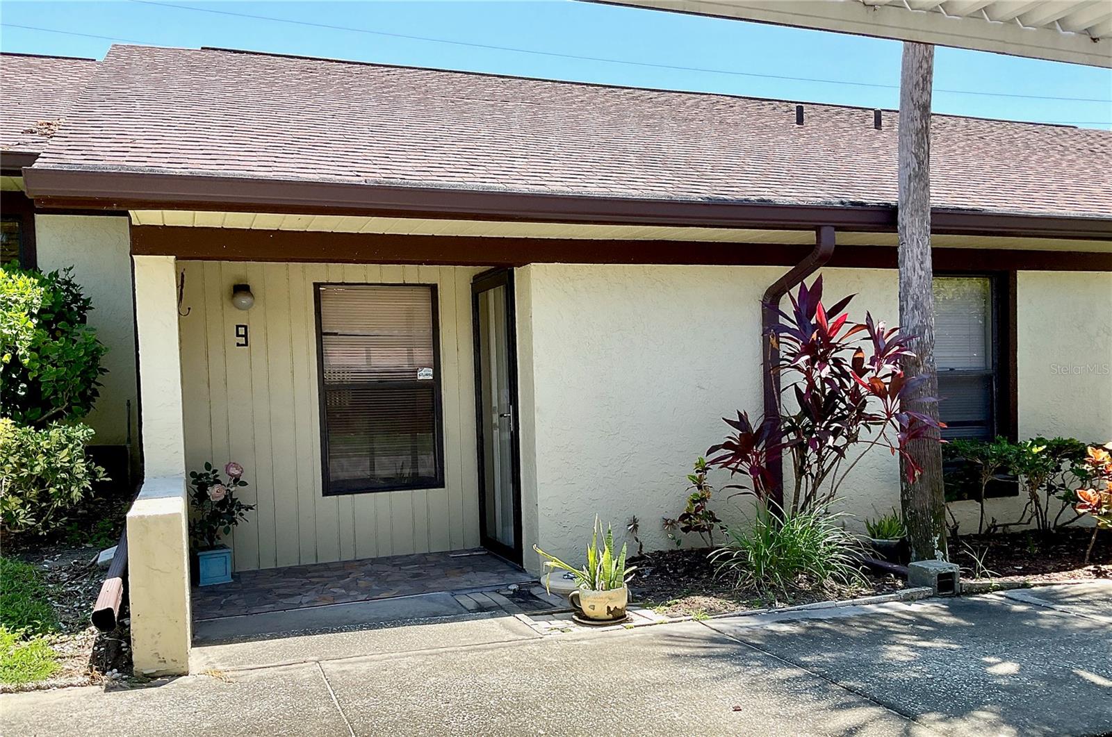 This 2 Bedroom, 2 bath, 970 sq ft. in the all-age community of San Christopher Villas nestled in the city of Dunedin is a fantastic opportunity for the first time homebuyer or someone looking to downsize. As you enter you will notice that there is updated tile flooring throughout, the kitchen has updated cabinets with extra countertop for food prep and the potential space for a dishwasher. Looking out from the kitchen is a breakfast bar area opening to large combo living/dining room. The living room and both bedrooms have updated fans. The guest bedroom is conveniently located near the updated guest bathroom and inside laundry room with washer and dryer. The primary bedroom boasts a walk-in closet and its own updated bath with a step-in shower. Enjoy outdoor living with an enclosed, screened lanai accessible from the living room. The air conditioner in this unit was replaced in 2019. The community offers amenities such as a clubhouse and pool, and the condo fee covers these essential services; cable, water, sewer, internet, roof, ground maintenance, exterior maintenance, pool maintenance., clubhouse, and property manager. An assigned, covered parking space and ample guest parking is available. Just minutes from downtown Dunedin, this location has easy access to restaurants, shops, the Pinellas Trail, beaches, and airports. Schedule your private showing!