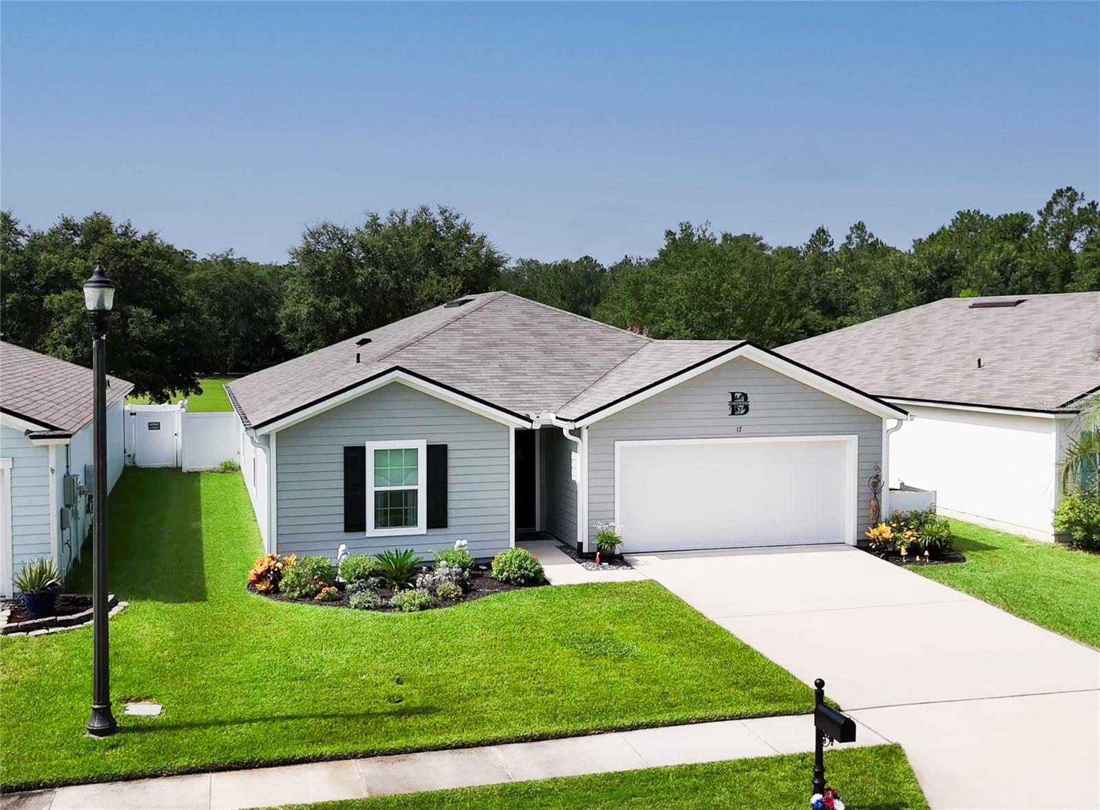 Welcome to your next home in Grand Reserve, a beautifully maintained, golf cart-friendly community just 15 minutes from the sandy shores of Flagler Beach. This property features gorgeous park views, thoughtful upgrades throughout, and access to resort-style amenities in a peaceful, friendly neighborhood.
Inside, you’ll find a bright, open-concept floor plan that’s both functional and inviting. The living and dining areas flow effortlessly into the kitchen, creating a perfect layout for everyday living and casual entertaining. Luxury vinyl plank flooring has replaced all the standard flooring, giving the home a modern, cohesive look.
Step outside to enjoy gorgeous park views from your expanded patio and a spacious 12x16 screened lanai with an epoxy-coated floor—perfect for relaxing or entertaining. The home also includes an 8x10 TuffShed with electricity, offering versatile space for storage, hobbies, or a workshop. A full gutter system has been installed around the house, and in the garage, you’ll find a utility sink along with a water softener and water filter system. For added convenience and efficiency, a generator switch panel and gas fittings have been installed. Additionally, a hot water recirculation system has been added to provide quicker access to hot water, and rubber mulch landscaping has been used to maintain vibrant color and durability.
This home is set in a vibrant community that encourages an active lifestyle with a resort-style pool, pickleball and bocce courts, a fully equipped fitness center, and a community clubhouse with regular events. Sidewalks and walking trails wind throughout the neighborhood, ideal for morning strolls or evening golf cart rides.
With nearby shopping, dining, medical services, and easy access to I-95, this home delivers the perfect balance of comfort, convenience, and community. Don’t miss your chance to own this beautifully upgraded, move-in-ready home with park views and top-tier amenities in Grand Reserve.