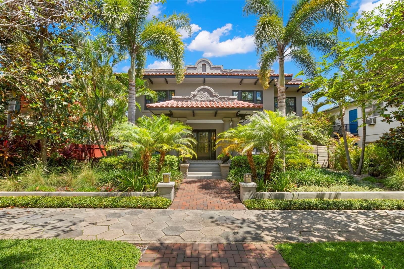 Welcome to 345 8th Ave NE, a standout Mission-style property in the heart of Historic Old Northeast—just steps to Beach Drive, one block to the waterfront, and three blocks to The Vinoy. Blending 1920s charm with modern upgrades, this home offers flexible living, income potential, and resort-style outdoor spaces—all in one of St. Petersburg’s most sought-after neighborhoods. The main residence features 3 bedrooms, 2.5 bathrooms, and over 2,800 SF of thoughtfully updated living space. Renovated by Strobel Design Build in 2018, it showcases original built-ins, beautiful original hardwood floors, 9-foot ceilings, and rich period details throughout. The spacious family room and open-concept layout offer effortless flow for both entertaining and everyday comfort. The gourmet kitchen includes Viking appliances, concrete countertops, a farmhouse sink, shaker-style cabinetry, and an adjoining sitting room. Upstairs, you’ll find all three bedrooms and two full baths, including a generous primary suite. The third bedroom is currently used as a large walk-in closet but can easily be converted back into a traditional bedroom. A covered breezeway connects the main home to a 1-bedroom, 1-bath guest casita with its own full bath—offering a private retreat just steps from the heated 39’ x 10’ saltwater lap pool with waterfall features, travertine pavers, Trex decking, and lush tropical landscaping. A separate covered outdoor dining area completes the backyard resort experience. In addition to the main residence and casita, the property includes a legally zoned, detached 1-bedroom, 1-bath Accessory Dwelling Unit (ADU) featuring approximately 600 SF, a full kitchen, in-unit laundry, private balcony, and dedicated parking built in 2018 and currently leased. The ADU offers excellent income potential or space for extended family and guests. The oversized 900 SF block garage includes 8.5’ ceilings, a 7.5’ door height (ideal for SUVs with roof racks), three large storage closets, and is complemented by three additional off-alley parking spaces—providing a total of five dedicated spots. Additional highlights include impact-rated hurricane windows throughout, new roofing (2024 and 2025), interior stair access to a nearly full-height crawlspace, and a portable generator hookup wired to run essential systems. Stunning design details and landscaping make this a truly special property. Located in Flood Zone X & in Evacuation Zone D. Schedule your private showing today to see a home that combines historic character, modern functionality, and unmatched walkability—just minutes from parks, dining, and everything downtown St. Pete has to offer.