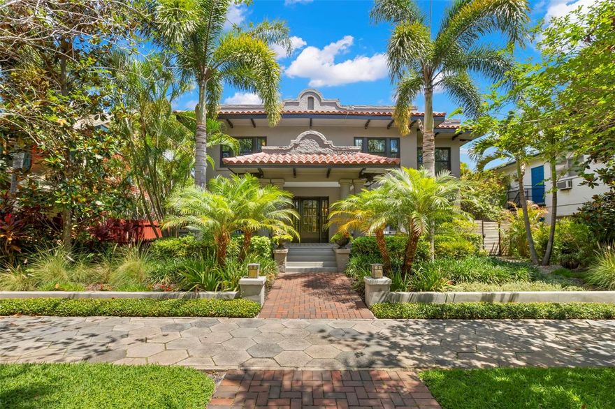 Welcome to 345 8th Ave NE, a standout Mission-style property in the heart of Historic Old Northeast—just steps to Beach Drive, one block to the waterfront, and three blocks to The Vinoy. Blending 1920s charm with modern upgrades, this home offers flexible living, income potential, and resort-style outdoor spaces—all in one of St. Petersburg’s most sought-after neighborhoods. The main residence features 3 bedrooms, 2.5 bathrooms, and over 2,800 SF of thoughtfully updated living space. Renovated by Strobel Design Build in 2018, it showcases original built-ins, beautiful original hardwood floors, 9-foot ceilings, and rich period details throughout. The spacious family room and open-concept layout offer effortless flow for both entertaining and everyday comfort. The gourmet kitchen includes Viking appliances, concrete countertops, a farmhouse sink, shaker-style cabinetry, and an adjoining sitting room. Upstairs, you’ll find all three bedrooms and two full baths, including a generous primary suite. The third bedroom is currently used as a large walk-in closet but can easily be converted back into a traditional bedroom. A covered breezeway connects the main home to a 1-bedroom, 1-bath guest casita with its own full bath—offering a private retreat just steps from the heated 39’ x 10’ saltwater lap pool with waterfall features, travertine pavers, Trex decking, and lush tropical landscaping. A separate covered outdoor dining area completes the backyard resort experience. In addition to the main residence and casita, the property includes a legally zoned, detached 1-bedroom, 1-bath Accessory Dwelling Unit (ADU) featuring approximately 600 SF, a full kitchen, in-unit laundry, private balcony, and dedicated parking built in 2018 and currently leased. The ADU offers excellent income potential or space for extended family and guests. The oversized 900 SF block garage includes 8.5’ ceilings, a 7.5’ door height (ideal for SUVs with roof racks), three large storage closets, and is complemented by three additional off-alley parking spaces—providing a total of five dedicated spots. Additional highlights include impact-rated hurricane windows throughout, new roofing (2024 and 2025), interior stair access to a nearly full-height crawlspace, and a portable generator hookup wired to run essential systems. Stunning design details and landscaping make this a truly special property. Located in Flood Zone X & in Evacuation Zone D. Schedule your private showing today to see a home that combines historic character, modern functionality, and unmatched walkability—just minutes from parks, dining, and everything downtown St. Pete has to offer.