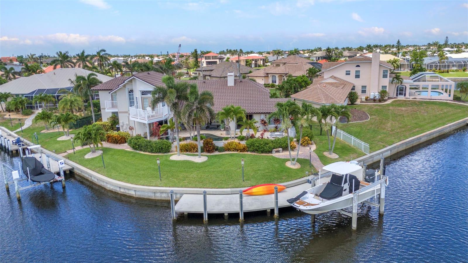 Welcome to 250 Freeport Court, an exquisite residence that embodies sophistication,
craftsmanship and prime Florida waterfront luxury. Situated on a coveted tip lot within the
exclusive Punta Gorda Isles community, this stunning two story estate offers an unparalleled
blend of elegance, functionality and panoramic water vistas.
Boasting 150 feet of prime intersecting canal footage and swift harbor access, this home provides the ultimate setting for
boating, fishing and embracing the Gulf Coast’s vibrant marine lifestyle.
This residence’s extraordinary features include a brand new tile roof, freshly painted
exterior, dual AC units, two hot water heaters, full exterior hurricane shutters and a host of other
custom upgrades that elevate its elegance and comfort.
From the moment you arrive you are greeted by impressive curb appeal, a pillared double front entry and lush tropical landscaping.
Step inside to an open and bright floor plan with vaulted ceilings, plantation shutters, and designer fixtures throughout. The first level offers over 2,900 square feet of luxurious living space, including a spacious primary suite with a large private bathroom, walk-in closet and a
versatile bonus room–perfect for a home office, gym or media room. T
The expansive Great Room with a cozy fireplace seamlessly connects to the gourmet kitchen, featuring stainless
steel appliances, granite countertops, a large breakfast bar and a breakfast nook.
A spacious den adds to the home’s flexible layout. The first floor also features a large laundry room with
granite counters, overhead cabinets and utility tub, plus an oversized two car garage with
workshop area.
A private guest wing includes a first floor bedroom with water views and a full bath with
pool access. Upstairs is a third bedroom with a private balcony for serene morning sunrise
views. A versatile loft area overlooks the main living space and serves as a fourth bedroom. A
third bathroom serves both areas. The loft provides access to a large balcony overlooking the
lush pool and offers a tranquil waterfront panorama. This is a perfect area for relaxation or
entertainment.
When opened, a three panel pocket slider creates a unique open feeling and seamlessly
connects the indoor and outdoor living spaces. Outdoors you can indulge in your private resort
style heated saltwater pool and spa with three waterfalls, a large covered seating area and a
separate covered dining area.
The property’s exclusive tip lot offers the ultimate privacy and panoramic water views.
150 feet of water frontage boasts both a 60 foot and 30 foot long concrete docks, both with boat
lifts offering quick access to Charlotte Harbor and the Gulf. The seawalls are maintained by the
city of Punta Gorda ensuring long term durability and peace of mind.
Located just minutes from Fisherman’s Village, Gilchrist Park and downtown Punta
Gorda’s shops and fine dining, this home offers the perfect combination of waterfront serenity
and convenience. Don’t miss this rare opportunity to own a waterfront paradise in one of Punta
Gorda’s most desirable communities.
This is the home that you have been waiting for!