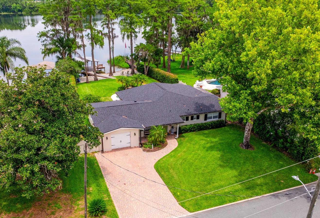 Seller may consider buyer concessions if made in an offer | Lakefront charm meets quiet luxury in the heart of Winter Park! This beautifully updated single story POOL HOME sits on nearly HALF AN ACRE of LAKEFRONT PROPERTY on the coveted LAKE BELL - a private SKI LAKE - offering a private dock/boat lift, character and contemporary upgrades that make everyday feel like a lakeside retreat. Major updates include a NEW ROOF (2022), A/C (2022), TILE FLOORING THROUGHOUT (2023), a COMPLETE KITCHEN RENOVATION (2023), and a FULLY REMODELED PRIMARY BATH (2023). Enjoy peace of mind with double pane windows, fresh interior and exterior paint (2022), and a septic system service also (2022). The home also features NEWER WINDOW TREATMENTS (2022), a new pool pump (2023), and NEW DOCK DECKING (2024)! Inside you will be pleased to find vaulted ceilings, an abundance of NATURAL LIGHT, and a light, bright OPEN FLOOR PLAN that flows seamlessly between formal and family spaces. From the moment you enter you are greeted with UNINTERRUPTED LAKE VIEWS, setting the tone for a home designed around its beautiful surroundings. The layout includes a spacious FLORIDA ROOM overlooking the pool and lake beyond – perfect for year round enjoyment! Step outside to your private outdoor oasis featuring an open-air pool with waterfall feature, patio, lush landscaping and a fun in the sun SAND BEACH leading to your private dock. Sunset views over the water are a daily luxury! Located in one of Winter Park’s most desired neighborhoods, you are only minutes away from top-tier dining, boutique shopping, parks, and major roadways like US 17/92, Orlando Ave and I-4. With its blend of charm, modern updates, and an unbeatable lakefront setting, this home truly is a rare GEM. Call today to schedule your tour and start living the LAKE LIFE – where every day feels like a vacation!