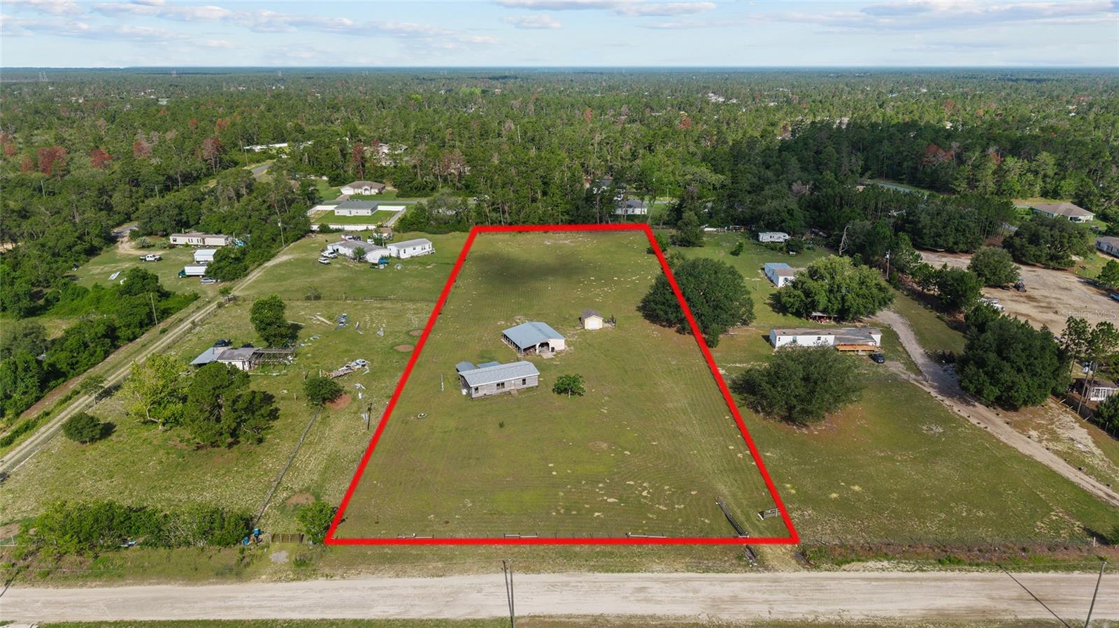 Welcome to your slice of country paradise in Marion Oaks Ranches! This exceptional 3-acre property is fully cleared, zoned agricultural, and ready for your dream home or mini-farm. Bring your horses, livestock, and your imagination—this land offers endless potential. Essential utilities are already in place, including electricity, well, and septic—with the septic system pumped and inspected in 2024 for added peace of mind. The property also includes two tool sheds/workshops, ideal for storage or hobby use. While the existing mobile home is not currently habitable, it has been partially updated with a new roof, range, dishwasher, and more—presenting future potential as a guest house, office, or project space. Conveniently located just 1 mile from a brand-new high school opening in August 2026, the area is on the rise. Once completed, the school will serve nearly 3,000 students and include a 2,000-seat stadium, plus fields and courts for football, baseball, soccer, track and field, tennis, and beach volleyball. Everyday essentials are also just minutes away with a new ALDI grocery store recently opened in the neighborhood, offering quick access to fresh, affordable food. Whether you're looking to build, invest, or create your ideal rural retreat, this ready-to-go property offers the perfect blend of space, infrastructure, and future growth potential.