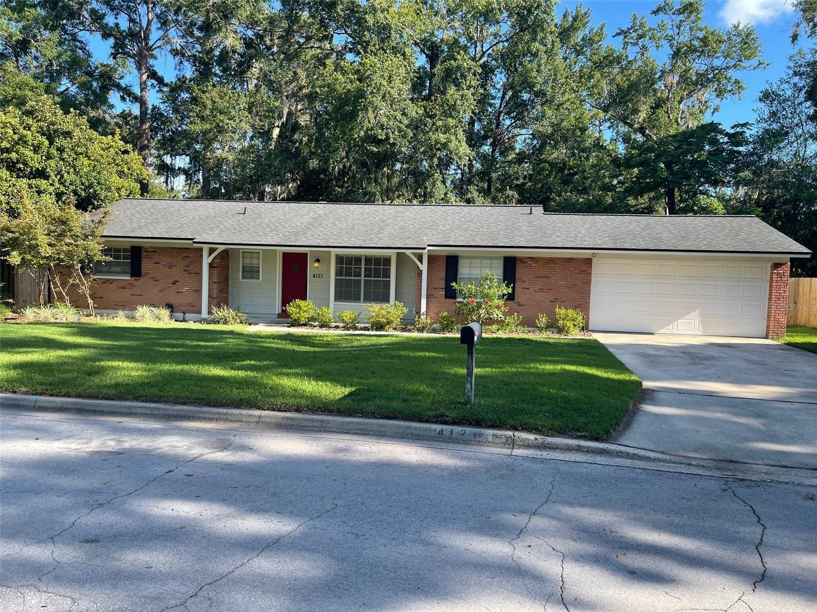 Beautifully Updated Mid-Century Home with Concrete Block and Brick Facade This charming mid-century home blends classic design with modern updates. Situated on a spacious lot, it features an enclosed backyard perfect for entertaining friends and family. Inside, you'll find new carpeting in all bedrooms and stylish updated tile throughout the main living areas. The newly renovated kitchen and master bathroom provide cozy, contemporary comforts, while a cheerful breakfast nook sits just off the kitchen. The open-concept formal dining and living room combination creates a welcoming space for everyday living or hosting guests. Conveniently located just minutes from the UF Law School and University of Florida main campus, this home is move-in ready with recent upgrades including a newer HVAC system, roof, and hot water heater. Nestled nicely less than a mile from the Publix Millhopper Shopping Center, you'll also enjoy easy access to a variety of nearby restaurants and amenities including Gainesville Health and Fitness less than a bike ride away. Don’t miss the opportunity to call this updated gem your new home!