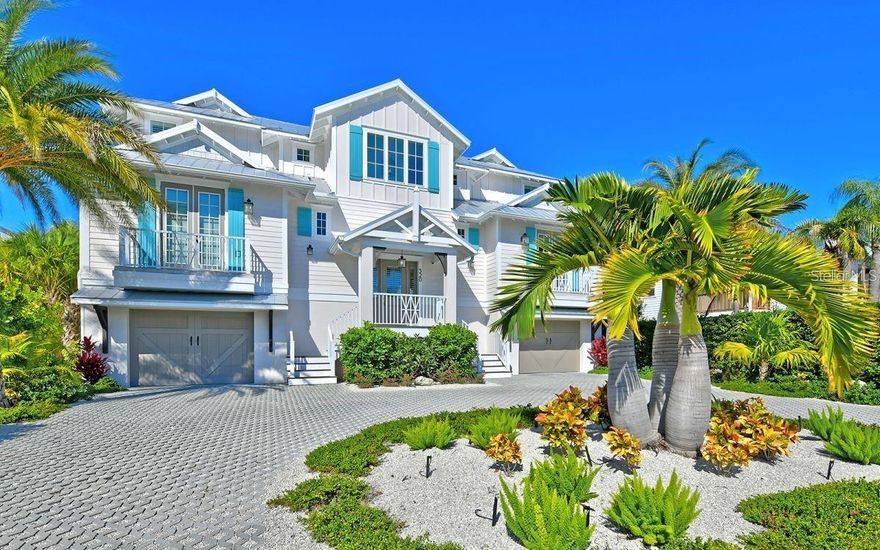 Island Living at its finest! No detail has been overlooked in this impeccably built 4-bedroom, 4.5-bath waterfront pool home in the heart of Anna Maria. The open plan main level has abundance of natural light – perfect for entertaining or family living. You’ll find rich hardwood flooring, beamed and vaulted ceilings, a great room, elegant dining room, and a gourmet kitchen. The ideal space for gathering – this kitchen is every chef’s dream, with shaker-style wood cabinets, quartz counters, large island with breakfast bar, stainless steel gas appliances and detailed tile backsplash. In addition to 4 large bedrooms, you’ll find an executive office. The sumptuous master suite boasts a beautiful bathroom with his and hers vanities and spa-like shower. Outside, you’re surrounded by lush landscaping for ultimate privacy. Enjoy tons of living space, covered and uncovered. The large resort style saltwater pool has a shallow lounge area, plus umbrella shaded seating and heated spa. Stay and relax and lounge by the pool, or take off from the dock to enjoy the Gulf of Mexico. Deep water with no bridges. This home has every upgrade, from Bermuda shutters, the circular drive to your 3-car garage, and elevator to all levels. If you’re looking for ultimate luxury and clean coastal design – you’ve found it! Plus, you’re within steps to restaurants, boutiques, and the white sandy beaches of Anna Maria.