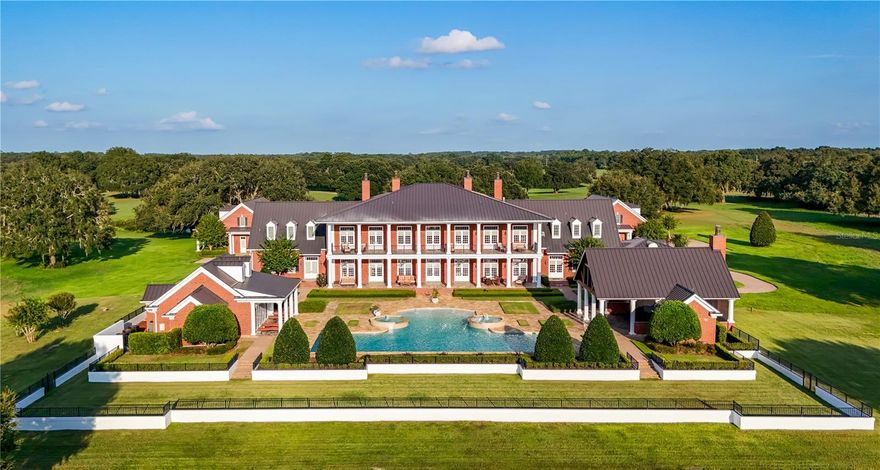 !!! HUGE PRICE REDUCTION !!!! Grandiose and serene 50 acres Estate, meticulously maintained, in Marion County, close to Mount Dora, the Villages, many Lakes, Leesburg, and the Ocala National Forest. Only 1h from Orlando International Airport.
Designed in the purest European tradition with a perfectly symmetrical architecture, concrete blocks from bottom to roof, a Mansion with an impressive foyer, elevator, elegant dining room, impressive kitchen, cosy family room with gas fire place, library, movie theater, office, safe room, 3 half bathrooms and on the second floor, master suite, ensuite bedroom, flex room that could be a 3rd bedroom, extensive laundry and a half bathrooms, 2 covered patios. 
There is a remarkable resort style pool, fountain, jacuzzi, a dining pavilion with kitchen, a wellness center with bathrooms, sauna and gym.
For your guests, a lovely and spacious house with 3 ensuite Bedrooms, laundry, Kitchen open to the Dining / Living room.
A spacious 5 cars garage with workshop, full bathroom, dog wash and storage in the 2nd floor. 
A barn shop for the agricultural equipment, in the back of the property, with a climate control room, a full bathroom and a generator.
Outside: Mature trees, dog run, 3 shooting ranges (25ft for pistols, 200 and 400 yards for rifles and long guns), Multiple water birds and grey cranes by the 2 ponds stocked with fishes.
Also 2 commercial generators (2 weeks autonomy), dehumidifiers, Creston system and more. No Zone restriction.
Amazing opportunity to take over this legacy. An estate for generations. 
No Zone restriction. Watch the video on YouTube. It's UNIQUE!