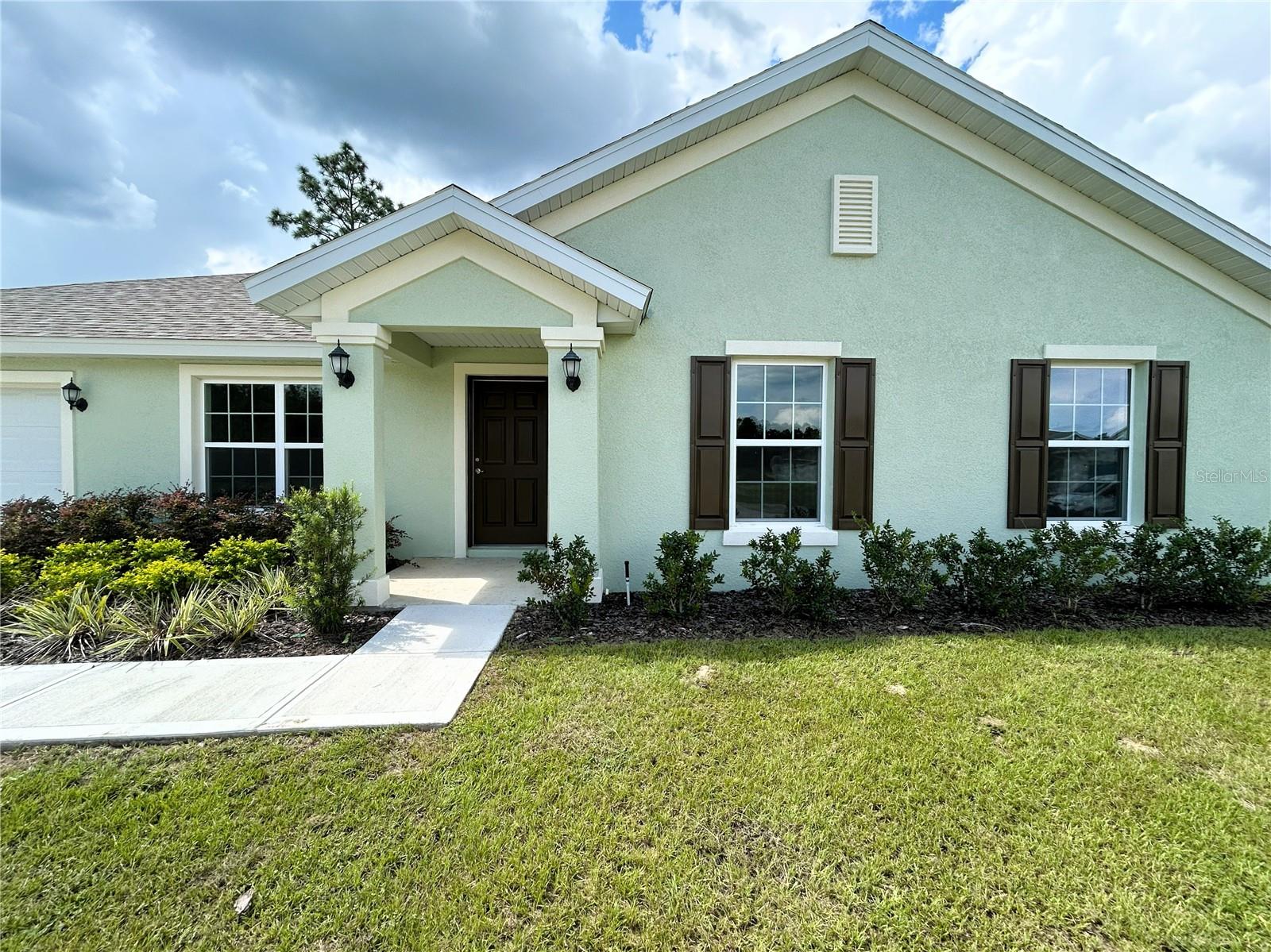 WOW! Take in this eye popping 3-bedroom 2-bath new construction home built by The Deltona Corporation. Walk in and be greeted with a vast open floorplan. Immediately notice the tall, vaulted ceilings and thoughtful kitchen that boasts beautiful granite countertops and soft close premium cabinets. Sizeable master bedroom with a double vanity bathroom that offers an all tile walk in shower. Other great features this home offers include Indoor laundry room, a full irrigation system, in wall pest defense system, large back patio, 30-year architectural shingles, and a 10-year warranty with an in-house warranty manager. Nestled in a wonderful and peaceful neighborhood with sewer, public water, and underground utilities. This cozy brand-new home is ready for its owners, don't wait on this one it's worth it, give me a call today