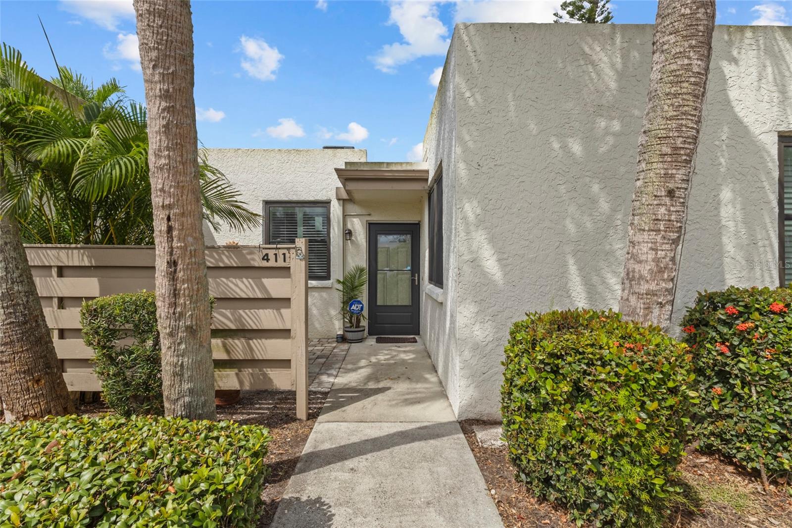 Nestled in the lush tropical landscape of Wildwood Springs, this charming ground floor condo offers a rare blend of privacy, comfort, and convenience with its beautifully maintained 2BD/2BA layout. Step inside to find an inviting open floor plan that flows effortlessly from the dining area into the crisp, updated kitchen featuring sleek cabinetry, stainless steel appliances, and a farmhouse style sink, perfect for both everyday living and entertaining. Updated bathrooms. Natural light fills the spacious living area, which opens directly into a tranquil Florida room where floor-to-ceiling windows invite the outside in and provide a peaceful view of manicured landscaping. A private front patio offers a welcoming entryway and a second space for enjoying Florida's year round sunshine. With tasteful upgrades and neutral tones, this residence is move-in ready yet provides plenty of opportunity to personalize. Community amenities include a heated pool and tennis/pickleball. Nestled within a sought after community known for its serene lakes and mature trees, this condo is a wonderful place to call home whether you're looking for a full-time residence or a seasonal retreat.