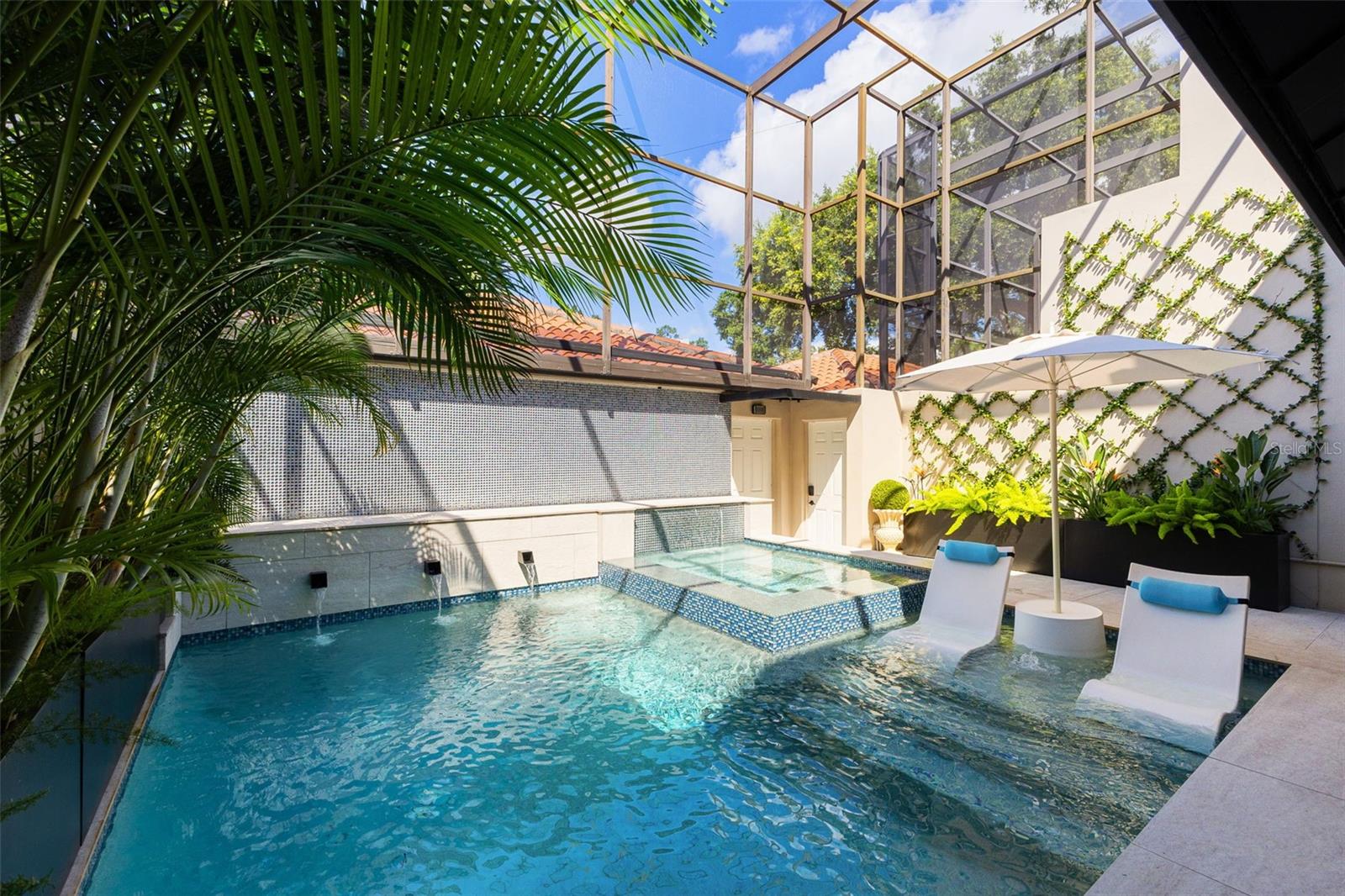Welcome to an extraordinary 3-bedroom, 3-bath residence in the gated Adeste community—offering the rare combination of a private in-unit elevator, 3-car garage, and your own screened-in pool and spa. No other condo in Tampa Bay compares.
Step inside and discover two spacious living rooms, each designed for both comfort and elegance. One living area showcases a dramatic dual-sided fireplace with floor-to-ceiling marble and a custom wrap-around bench, creating a true statement piece. The second dual-sided fireplace enhances the luxurious primary suite, connecting the bedroom to its spa-like bathroom.
The chef’s kitchen is both functional and stunning, anchored by an oversized waterfall quartz island and featuring abundant cabinetry and storage. Entertain effortlessly in the formal dining room—currently styled as a piano lounge—with a wet bar and Fine Art Lior Silver Glass chandelier that sets the tone for upscale gatherings.
Throughout the home, no detail has been spared—from oversized porcelain tile to a Fine Art Handcrafted Lior Glass Light Fixture and premium high-profile carpeting in the bedrooms. Solid core doors with Emtek Select handles, chrome-plated twisted faucets in the primary bathroom, and custom in-cabinet outlets add subtle luxury. Natural light floods the space through skylights in the upstairs living room and primary bathroom. The primary suite also includes a private balcony overlooking your private backyard oasis!
The private, enclosed patio is truly breathtaking—completely resurfaced in 2024 and featuring a reimagined pool and spa with upgraded water features, perfect for both relaxing and entertaining year-round. Fully enclosed and screened in. Also features a Pentair automatic system to control everything from your phone!
Additional Upgrades & Amenities; 2024 hurricane-rated windows, French doors, and new glass front entry, Custom elevator finishes including mirrors, wainscoting, and magnetic access panel for discreet storage and water heater. Epoxy-coated 3-car garage with overhead storage racks installed. Textured wall coverings throughout for depth and warmth. Carpeted stair runner for added comfort and style
Enjoy the privacy and luxury of single-family living with the low-maintenance convenience of a condo. Located just steps from Bayshore Boulevard, Hyde Park Village, and the best dining and shopping in South Tampa.
Bonus: Seller is open to selling select furniture and golf cart separately.
Elegant, bold, and entirely unique—this home is unlike anything else on the market. Schedule your private showing today and prepare to be impressed.