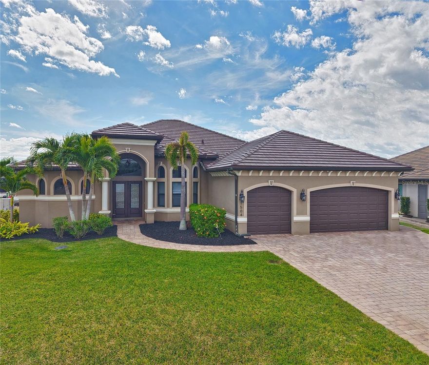 TRUE FLORIDA Living in this Luxury home. Custom built by Sinclair Homes. Southern Exposure, sellers say only 30 minutes to open water. Situated on an oversized 90x125 lot along the Santanita Canal with 1 bridge. This 4-bedroom home (3 bedrooms plus den/office) offers an open floor plan with Zero-Corner sliders, soaring ceilings, 8-foot solid doors, travertine flooring, crown molding, tray ceilings, and custom lighting and fans throughout. The kitchen features soft-close cabinetry, extended center island, leathered granite countertops throughout the home, wine fridge, and bar sink. Laundry room includes cabinetry and sink. The primary suite has lanai access, two walk-in closets with motion lighting, Jacuzzi tub, walk-around multi-head shower, heated towel rack, and bidet toilet. All secondary bathrooms include GFI outlets for future bidet installation. Outdoor living includes a picture-frame screened lanai, gas-heated pool, 7-person spa, outdoor kitchen with built-in gas grill, bar sink, leathered granite countertops, and LED lanai lighting. Home is powered by a 500-gallon buried propane tank with gas line extended to the dock for future fire pit and prewired for a whole-house generator. 
Oversized composite dock with lighting, tiki hut, covered boat lift canopy accommodating up to a 32-foot boat. Additional features include a 3-car garage with epoxy floors, dedicated A/C, custom storage, walk-up attic with spray foam insulation, water softener, heavy-duty water tank, two A/C units, irrigation system, built-in surround sound in great room and lanai, and extensive storage throughout. Professionally maintained pool, landscaping, and pest control. All city assessments paid in full. Convenient to shopping and restaurants.