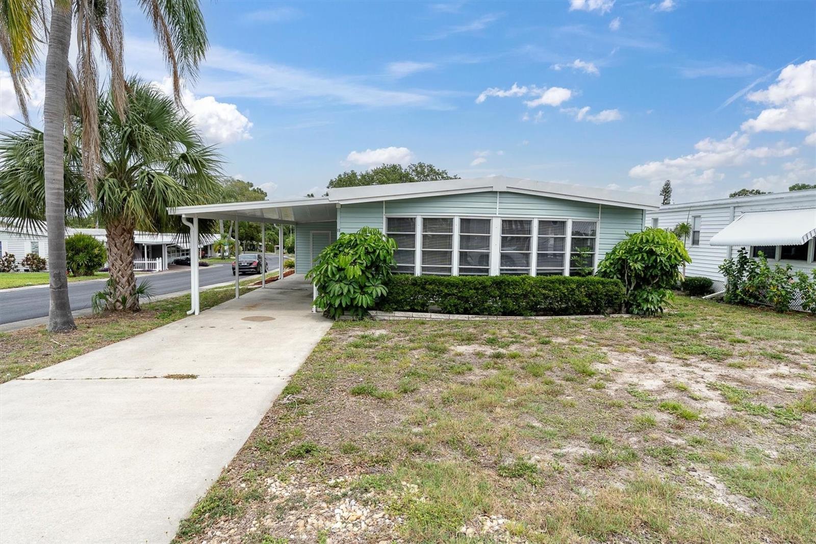 LOWEST PRICED HOME PER SQUARE FOOT! Spacious & Inviting Corner Lot Home in Palm Hill Country Club – Share Included!
Welcome to your Florida retreat! This 2 bedroom, 2 bath, 24x55 (1,320 sq. ft.) manufactured home is nestled on a large corner lot in the highly desirable 55+ Palm Hill Golf & Tennis Community. Priced at $149,900—share included ($35,000 value)—this home offers incredible value, charm, and space.
Interior Highlights:
Open Living & Dining Areas with abundant natural light
• Bright Kitchen with LED lighting and breakfast bar, newer dishwasher, new backsplash and freshly painted.
• Spacious primary Suite with walk-in closet plus a second closet, built-in vanity, and en-suite bath with step-in shower & grab bars
• Guest Bedroom with built-in dresser and ample storage
• Hall Bath with tub/shower combo, large vanity, and linen cabinetry
• New Vinyl Flooring & Subfloors
• Newer HVAC (Dec. 2022)
Exterior Features:
• Blue Vinyl Siding with crisp white trim
• Insulated Roof Over
• Carport with parking for 3+ vehicles
• 8x15 Workshop/Shed with laundry hookups
• Surrounded by mature trees and beautiful landscaping
Community Amenities:
• $554./month maintenance fee includes: cable TV, internet, water, sewer, garbage, lawn care, and more!
• 5-Star 55+ Palm Hill Country Club
• 3 Swimming Pools, Hot Tubs, Tennis Courts, 2 Clubhouses
• Golf course, shuffleboard, social clubs, and tons of planned activities.
This home offers both comfort and peace of mind with all major updates complete. Don’t miss out on this rare corner lot gem! Call today to schedule your showing today.