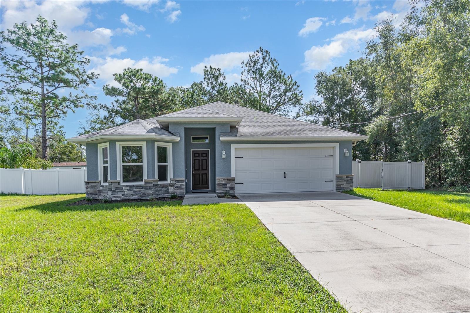 Discover this stunning home in one of Marion County’s most desirable neighborhoods, where style, comfort, and functionality come together beautifully. Built with concrete block and stucco accented by stone, the home offers both durability and timeless curb appeal.
Inside, you’ll find a unique open-concept split floor plan designed for privacy and convenience. The spacious entryway opens to soaring vaulted ceilings, while the gourmet kitchen boasts granite countertops, stainless steel appliances, soft-close cabinetry, and LED lighting—perfect for entertaining.
The owner’s retreat is a true sanctuary, featuring dual walk-in closets, a spa-like bath with a custom tiled shower, double vanity, and pocket doors for added elegance. Additional highlights include a dedicated laundry room, two-car garage, and NO carpet throughout.
Generous in space and rich in features, this home is ready to impress—schedule your private showing today!