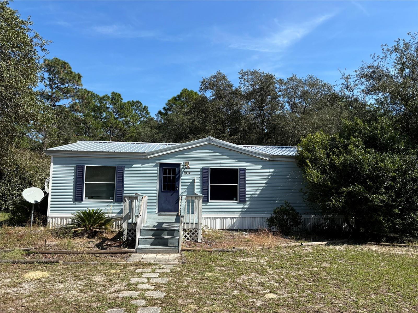 Calling All Investors!! Rural Living with Close Proximity to Ocala where there is NO HOA!! 2 bedroom, 2 bathroom with right under 1,000 square feet. This cute double-wide sits on 1/2 of an acre lot in Rainbow Lake Estates. Beautiful Floor Plan with Split Bedrooms. Both Bedrooms are very spacious. Huge Primary Bathroom with Walk in Shower. Metal Roof 2022. HVAC system updated in 2022. Upgraded Kitchen Fridge. Covered Deck. Huge Backyard that has a storage shed and ample space for entertaining. Plenty of Trees to enjoy the shade. Completely fenced property with entry gate. Storage Shed in the backyard. NO FLOOD ZONE. Less than 15 minutes to Rainbow River Springs State Park. Less than 30 minutes to downtown Ocala. Cash Only!!