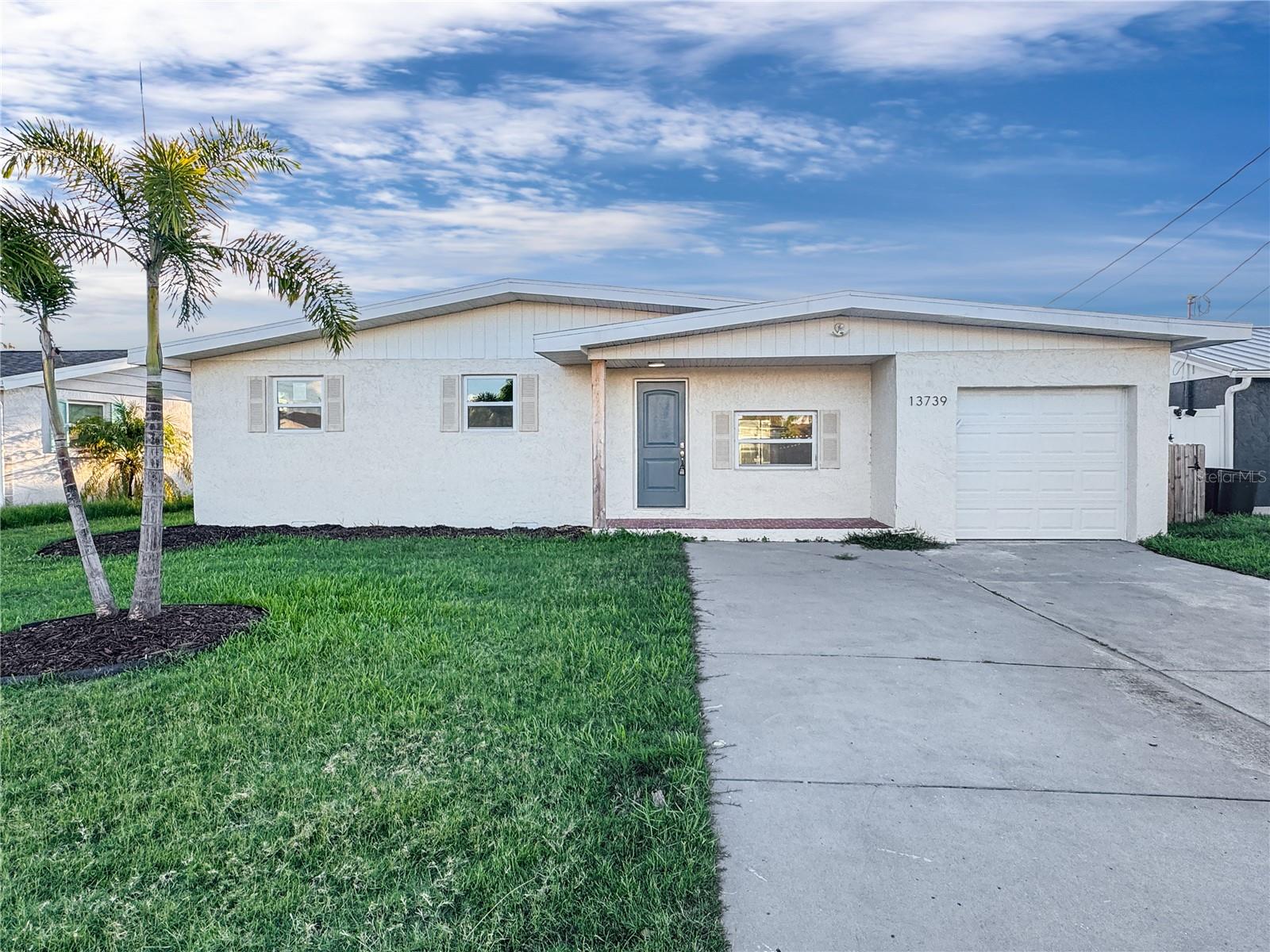 Imagine starting your mornings with coffee on the screened patio, the sunlight pouring into your open living space, and the peaceful sound of water just steps away. This beautifully updated home in Hudson Beach Estates offers the perfect balance of modern comfort and Florida lifestyle.
Inside, you’ll love the spacious open floor plan with vaulted ceilings, fresh paint, and new wide-plank floors that create a bright, airy feel. The kitchen is designed for both style and function, featuring crisp white cabinets, stainless steel appliances, and a clean, modern look that makes cooking a pleasure. The living room flows seamlessly to the backyard, giving you plenty of space to entertain or simply enjoy quiet evenings at home.
The bedrooms are comfortable retreats with updated finishes, modern ceiling fans, and natural light. The bathroom has been completely refreshed with a sleek, contemporary style.
Step outside and you’ll find a fenced yard with a firepit area, perfect for weekend gatherings, plus a screened lanai where you can relax bug-free all year long. Best of all, the property backs onto a canal with direct Gulf access, ideal for boaters, kayakers, or anyone who dreams of waterfront living.
With a one-car garage, updated systems, and low-maintenance block construction, this home is move-in ready. Located minutes from Hudson Beach, restaurants, and marinas, it’s a home where every day feels like vacation.