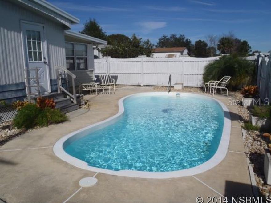 Spacious doublewide manufactured home with inground pool in desirable adult community. Office/Den could be used as 4th bedroom. Open kitchen and living area with bay windows in the living room and a couple of the bedrooms. Master bathroom has pool access. Great opportunity. Voluntary association approx. $25/yr if you want to join ;Water: City