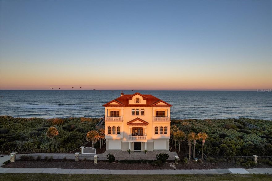 Introducing this stunning Hammock Dunes home located at 3747 North Ocean Shore Blvd. A pristine and extraordinarily detailed 2015 construction beachfront home compound with unimpeded ocean views from almost every room. This exclusive home’s design and construction quality is the definition of impeccable, with the highest attention to details. Spanning 5,700 sq. ft. over three levels, this elegant property overlooks miles of pristine beach. The perfect coastal design style boasts of custom woodwork including dark floors contrasting beautifully walls, 14’ high ceilings and an abundant amount of windows. The property’s construction was built to the highest standards with concrete block walls, concrete floors, pilings down to the bedrock and hurricane impact glass on all windows and doors. Step into the heart of the home, where an open floorplan seamlessly integrates the kitchen and family room, creating an inviting space for both entertaining and everyday living.The kitchen is equipped with modern appliances and ample counter space, making it ideal for culinary enthusiasts with Cambria quartz countertops and Thermador appliances to include a Wine Refrigerator, gas range and oven, built-in coffee/espresso machine, drawer microwave in the kitchen island, Refrigerator, and dishwasher. The room's design effortlessly flows into a welcoming family room overlooking the sparkling pool, inviting relaxation or entertainment. Adjacent to the kitchen is the charming dining area bathed in natural light providing an ideal space for guests or quiet nights watching the stunning and dramatic full Cambria-quartz stone wall with inset fireplace. The Great Room is the heart of the second floor with front and back walkout patios. The swimming pool is the centerpiece for gatherings on the terrace, while a private dune walkover whisks you down to miles of nothing, but the sand in your toes and the ocean brushing against the shoreline. Completing the first level is the main suite. The large bedroom, surrounded with windows, features custom built-in closets, private laundry room and ensuite bathroom with dual vanities, a soaking tub, and spacious shower overlooking the ocean. The extended dual vanities and additional make up table, cambria quartz countertops and chrome fixtures add elegance and style. The second main suite and remaining guest rooms are on the third level. The ensuite bathroom features dual vanities, a soaking tub, walk-in shower & closet, and ocean views from the private balcony for both oceanfront facing suites. A third guest bedroom offers closet place, ensuite bathroom, and a private balcony. The large gathering space in the middle makes a perfect bonus room or Media Room with custom built in wet bar and walkout balcony overlooking the pool. Down the hall sits the bunk room with 2 built-in sets of full bunk beds and en suite bath and a secondary laundry room for guests. Experience the functionality of this property with dual garages which can host 2+ cars in each garage with additional, air-conditioned storage spaces and mud room. Both garages host an expansive space with 10' high doors and 14' ceiling heights. Garage 1 has a 55 feet of depth which can easily accommodate an RV or boat. Security is not an issue as your property includes 5 outside cameras with nest station. The home is run by a Control 4 system for interior and exterior lighting, cameras, and sound throughout the home's interior.