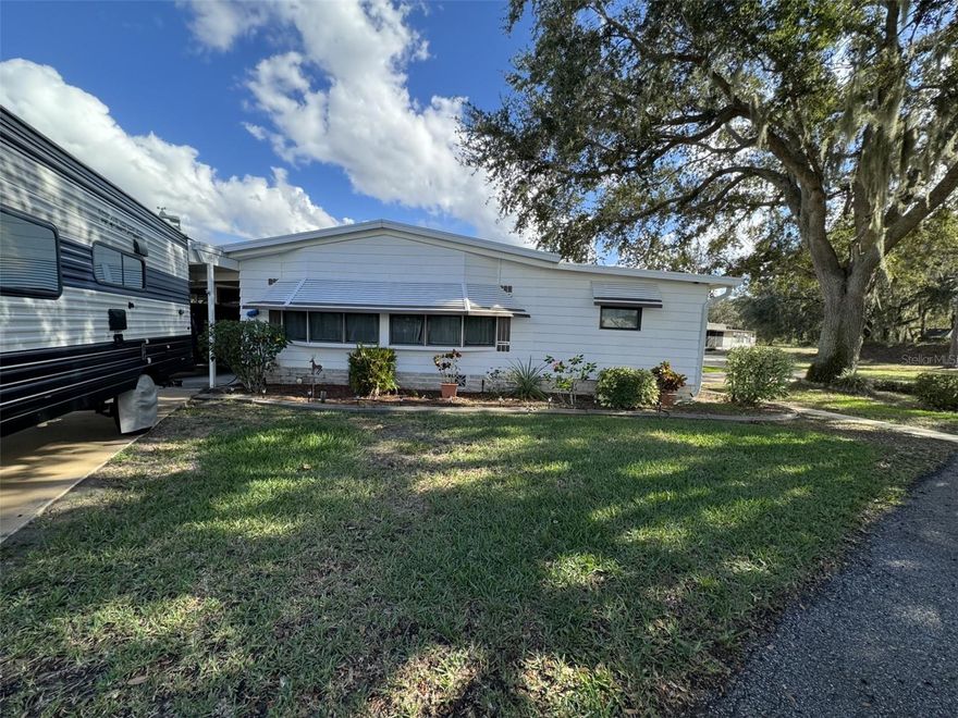 YOU OWN THE LAND!! with this beautiful 2-bedroom, 2-bathroom doublewide manufactured home located on a spacious corner lot in the desirable, rural, peaceful, 55+ lakefront community of Breeze Hill east of Lake Wales. This home has wonderful curb appeal with the beautiful landscaping that is in place. An irrigation system that helps keep that landscaping looking great year-round. This community sits on Lake Walk in Water, the largest lake in Polk County, and known for its trophy bass fishing. The roof is metal, and this home has all plywood subflooring, so you won't experience soft spongy floors. Upgraded with all new plumbing. Living room and Dining room floors are Italian Porcelain Tile. The galley style kitchen has been completely and beautifully remodeled with all new cabinets, counter tops, and flooring. Primary Bathroom has new sinks, granite countertop, and fixtures. Several new ceiling fans and light fixtures. Beautiful custom vertical blinds. Some of the furnishings will remain, and all appliances including washer and dryer. The seller is providing a home warranty for the buyer for a year. There is a 13 x 14 screened room on the back that has vinyl windows, and a large Florida/Family room on the front. Also includes a 10 x 14 Smithbilt shed. There is a LOT of parking with this home. Including full RV hookup. You will enjoy all the room for your boat, travel trailer, golf cart, and plenty left over for guests. Breeze Hill has an optional share program that allows homeowners to purchase a share for a one-time fee of $2,400. There is a monthly fee of $100.00 with this program to use the amenities the community offers, after the initial share is paid. The amenities include a heated pool, clubhouse with a lot of activities, shuffle-board court, community boat ramp, fishing tournaments and fishing pier. The community has boat slips and an outdoor storage area that are available for an extra charge on a first come first serve basis.