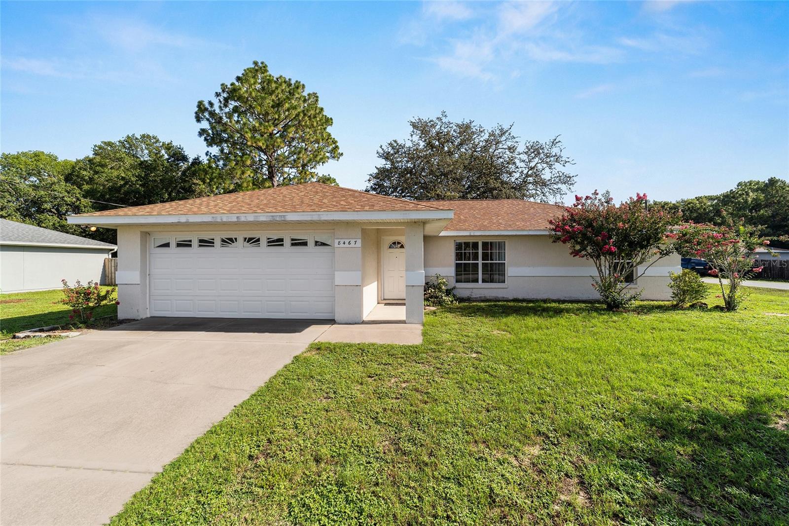 One or more photo(s) has been virtually staged. Discover comfort, convenience, and charm in this 3-bedroom, 2-bathroom home located in the desirable Belleview area. Roof 2021! The split floor plan separates the spacious Primary Suite (with its walk-in closet & double vanities) from the guest bedrooms, providing a peaceful retreat for everyone. You'll love the open-concept living space, highlighted by vaulted ceilings that creates a bright, airy atmosphere. The kitchen flows effortlessly into the dining and screened porch areas, making entertaining and everyday life a breeze. Step into the enclosed Florida room and enjoy the outdoors in total comfort—no bugs, no heat—just year-round relaxation. Outside, the oversized .30-acre corner lot provides a park-like setting with plenty of room to garden, play, or even add a pool. The two-car garage offers ample storage space and convenience, whether for vehicles, tools, or weekend projects. With no HOA and no CDD fees, this home offers the freedom to make it truly your own. Bring your toys, build a workshop, or create your dream backyard escape. Ideally located just minutes from The Villages, shopping, dining, medical services, and top destinations like the World Equestrian Center, you’ll enjoy easy access to all that Central Florida has—including Orlando and Gulf or Atlantic beaches, each just about an hour away. Don’t miss the opportunity to own a beautifully cared-for home that blends space, style, and a location that can’t be beat!