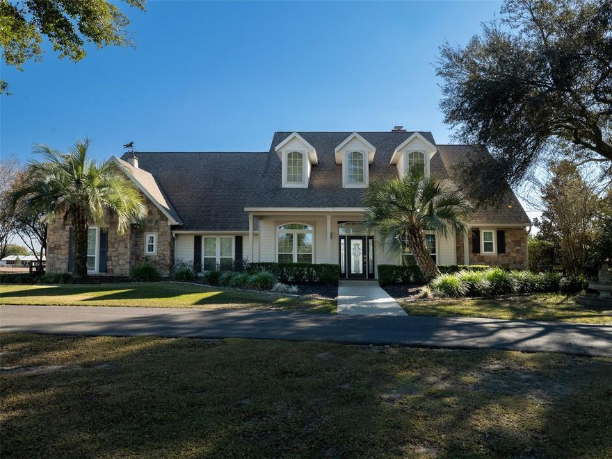 Situated less than 8 minutes from the World Equestrian Center and 10 minutes from HITS, this exceptional horse farm in the Wellington of Ocala subdivision offers an unparalleled opportunity for equestrian enthusiasts and luxury living alike. The property features 8 well-maintained paddocks, and a block, double center aisle barn which includes an apartment, 10 stalls, a tack room, feed room, office, bathroom, and wash racks, all designed with functionality and convenience in mind. Equestrian enthusiasts will also appreciate the 125x178 professional-grade arena with GGT footing, ideal for training and competition. The home on the property features 4-bedrooms and 2.5-bathrooms with high ceilings and porcelain tile flooring throughout. The kitchen is a standout, featuring beautiful white cabinetry, Antolini quartz countertops, and a large central island that’s perfect for both meal prep and entertaining. French doors open to the back porch, leading to the relaxing, beautifully landscaped outdoor oasis. The heated, in-ground pool with a waterfall and a koi pond with its own waterfall feature adds a peaceful touch to the entire property. The outdoor kitchen and bar area are perfect for hosting family and friends. With its proximity to world-class equestrian venues and an outstanding blend of luxury and functionality, this property offers an unparalleled lifestyle for both equestrians and those seeking the perfect home in a premier location. Additional acreage available at PID: 13010-000-08