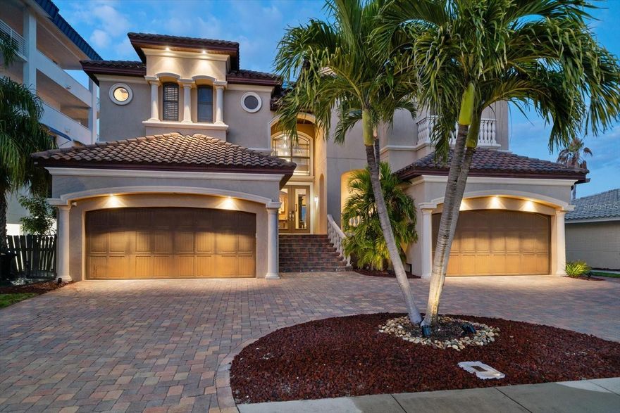 Nestled on one of Clearwater Beach’s most desirable residential streets, this stunning Mediterranean-inspired estate offers the rare combination of architectural presence, privacy, and resort-style outdoor living just moments from the beach. Designed for those who value both elegance and entertaining, the home makes a striking first impression with its grand façade, paver drive, and multiple garage bays, setting the tone for refined coastal living.

Inside, expansive open living spaces are filled with natural light and framed by detailed millwork, tray ceilings, and rich flooring throughout. The heart of the home is a chef’s kitchen designed to impress, featuring custom cabinetry, dramatic stone countertops, a professional-grade gas range with custom stone hood, premium appliances, and an oversized island that anchors the space, perfect for both everyday living and large-scale entertaining. The kitchen flows seamlessly into generous dining and living areas, creating an inviting atmosphere for gatherings.

The private primary suite is a true retreat, offering a spacious bedroom, serene finishes, and a spa-inspired bath with dual vanities, soaking tub, and oversized walk-in shower. Additional bedrooms and baths are thoughtfully designed to accommodate guests or family with comfort and privacy.

Step outside to a private outdoor living enclave designed to rival boutique resorts. A lagoon-style pool and spa are surrounded by lush landscaping, sun shelves, multiple seating areas, and ambient lighting, ideal for daytime relaxation or evening entertaining. Covered terraces and balconies extend the living space outdoors, creating an effortless indoor-outdoor lifestyle rarely found so close to Clearwater Beach.  Enhancing the home’s appeal is a fully integrated solar energy system designed to power the entire residence, seamlessly supporting modern, energy-efficient living.

This exceptional residence delivers the feel of a private coastal estate while offering convenient access to world-class beaches, dining, boating, and entertainment. A rare opportunity to own a statement home where architecture, lifestyle, and location come together seamlessly.
