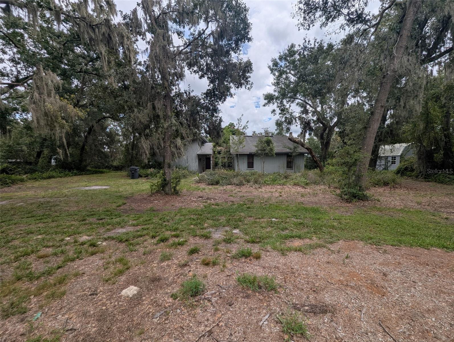 Unique Opportunity in South Lakeland: Your Dream Home Awaits!
Don't miss your chance to own a truly unique property in a charming, close-knit South Lakeland neighborhood. Nestled on just under an acre of land, this home is a blank canvas, ready to be transformed into your perfect family retreat. It's an opportunity to create a one-of-a-kind residence that stands out from all the rest.
The heart of the home is a central atrium, a true showstopper waiting to be restored to its former glory. This architectural feature creates a striking connection to the outdoors, with expansive windows in the kitchen, dining, and family room overlooking the space. The rough cedar trim and a matching wall of built-in shelves in the family room add rustic character and warmth.
The primary suite and family room are both generously sized, featuring large sliding glass doors that open to the back porch, perfect for enjoying a quiet morning coffee or hosting gatherings.
Outside, the property is a dream for those with hobbies and "toys." A separate, fenced-in area with direct access to Hatcher Road is perfect for parking a boat or RV. And with no HOA, you have the freedom to bring whatever you want!
This is more than a home—it's a lifestyle. It’s for the family looking to create lasting memories in a house that truly reflects their style. This is one to get your hands on.