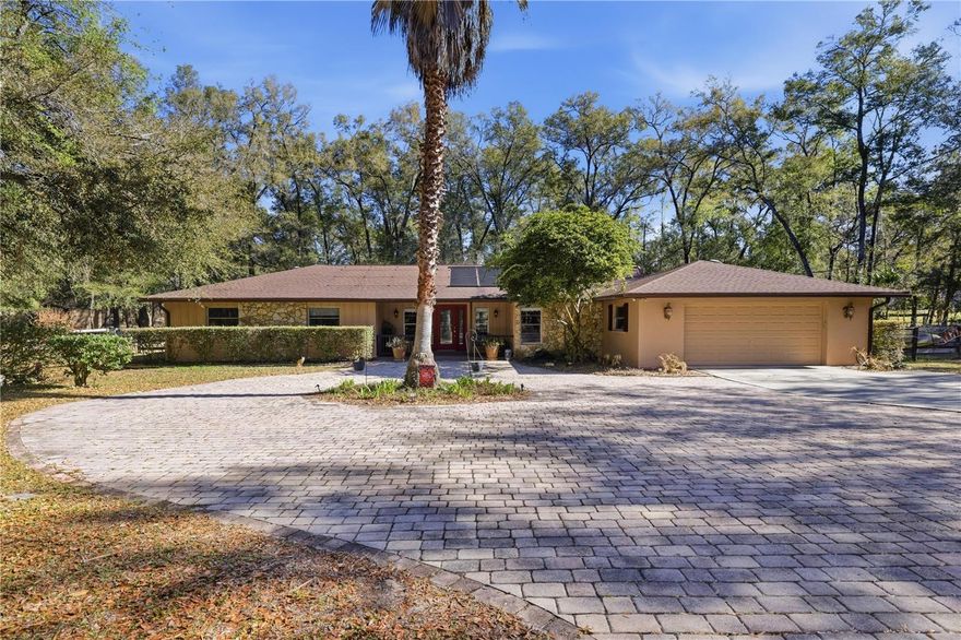 Nestled in the highly desirable equestrian community of Meadow Wood Farms, this beautifully maintained 4-bedroom, 2-bath farm sits on 5.3 fully fenced acres in the heart of Ocala’s horse country. Just a short drive to the renowned World Equestrian Center, this property offers the perfect blend of comfort and functionality for both horse and homeowner. The home features a remodeled kitchen with stainless steel appliances and rich cherry cabinetry. Both the interior and exterior have been freshly repainted, giving the home a clean, updated feel. Gather in the spacious living room around the large fireplace, with views overlooking the screened, heated saltwater pool—complete with all new pool equipment. A hot tub adds to the outdoor relaxation and is negotiable. Equestrians will appreciate the 4-stall center aisle barn equipped with water and electric, a tack room, wash rack area, and waterers to the paddocks. The property is fully fenced and welcomes you with a private electric gate at the entrance.  Enjoy peaceful sunsets, open space, and the true farm lifestyle in one of Ocala’s most sought-after equestrian communities.