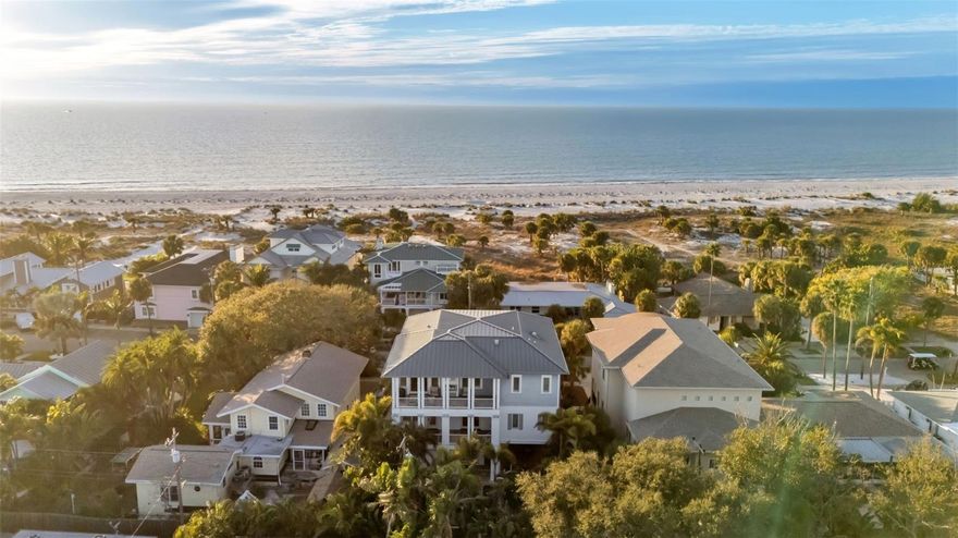 Stunning Gulf views without Gulf-front taxes. This beautifully designed contemporary home in the exclusive, private Carlouel neighborhood delivers the best of both worlds: sweeping water views and a quiet, secluded setting just steps from your own private gated beach access.
Built to the latest hurricane and flood standards with impact-rated windows and doors throughout, the home features reverse living so the main living areas and primary suite sit upstairs for maximum views and light. Soaring vaulted ceilings with handcrafted island-style wood beams, and custom millwork create an elegant yet relaxed coastal atmosphere. The chef’s kitchen is bright and expansive, complete with honed black granite, double Sub-Zero refrigeration, Wolf wall ovens, and a large farmhouse sink. 

Every guest bedroom has its own en-suite bath and generous closet space; while the primary suite offers double walk-in closets, dual vanities, and a deep soaker tub flooded with natural light and gulf views. An oversized garage, tons of interior storage rooms, and the elevator can be found on the first floor.

Outside, the spacious backyard is a true private oasis: saltwater pool and spa, large covered entertaining area, and multiple balconies perfect for morning coffee or evening sunsets. Just a 5-minute walk to the exclusive Carlouel Yacht Club (currently undergoing a $45 million transformation) and seconds from the gated beach path, this home puts you minutes from Clearwater Beach’s restaurants, shops, marina, and world-class attractions—without ever feeling crowded. Sophisticated coastal living at its finest.