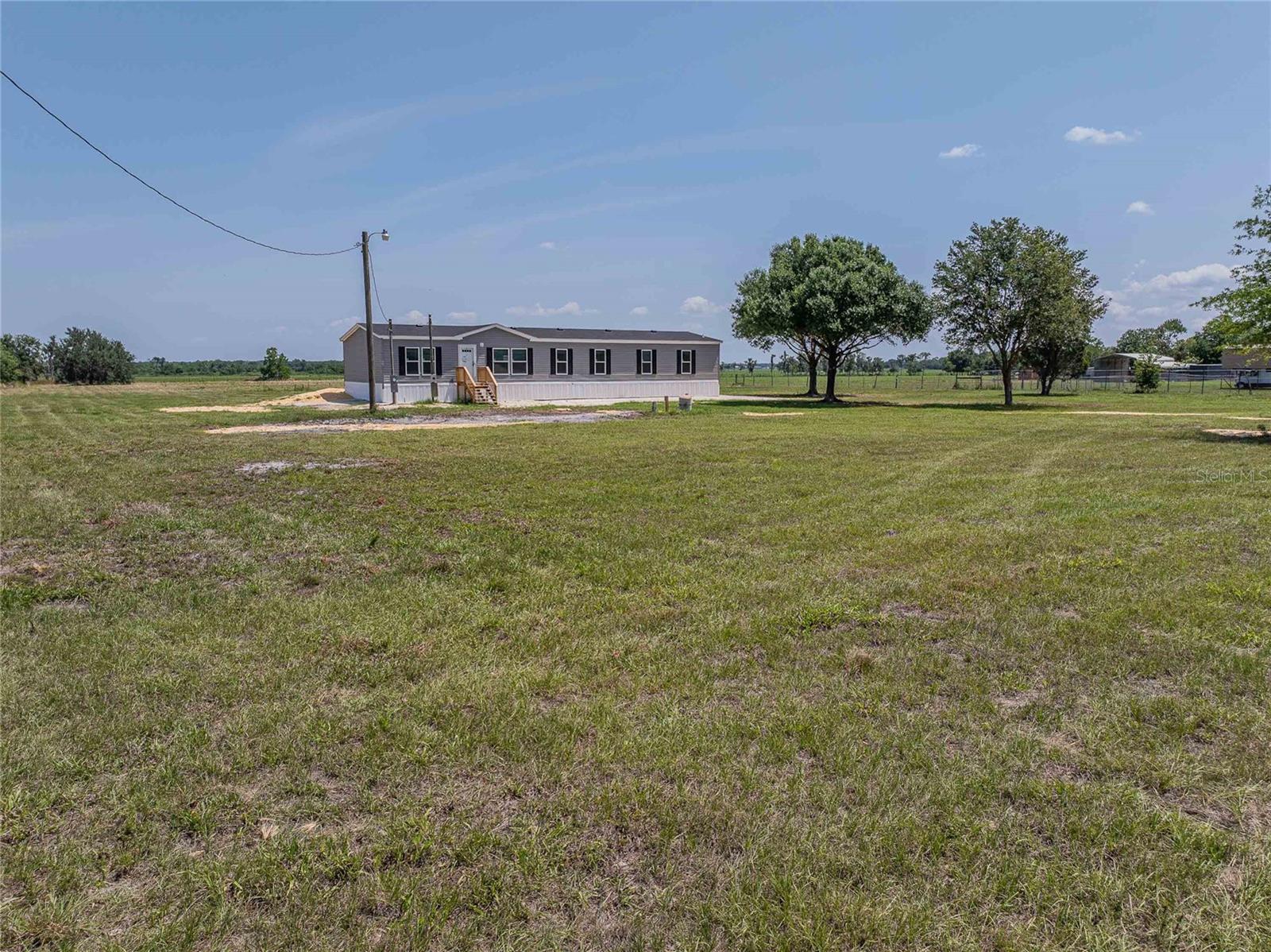 This is a one-of-a-kind property! Come see this BRAND-NEW DOUBLEWIDE manufactured home on ~ 5 ACRES in the lovely rural community of SUNRISE MEADOWS. Bring your horses, goats, chickens, or big toys and enjoy having space to indulge in hobbies that you've only ever dreamed of. Whether it's raising livestock and poultry or installing raised beds to grow your own food, this property will accommodate your dreams! This 3 BEDROOM 3 BATH SPLIT PLAN home has a LIVING ROOM, FAMILY ROOM, an OFFICE plus a BONUS ROOM. Everyone can spread out and have space to call their own. There is a KITCHEN ISLAND with additional seating as well as a separate DINING AREA. You will love the MASTER SUITE that extends the entire width of the home, and includes an ENSUITE BATHROOM with DUAL SINKS and an ENORMOUS WALK-IN CLOSET! As the FIRST OWNER, you won't have to worry about deferred maintenance or cleaning up after a prior owner. You don't want to let this one pass you by. Call your Agent to schedule a private showing before someone else steals your dream property!