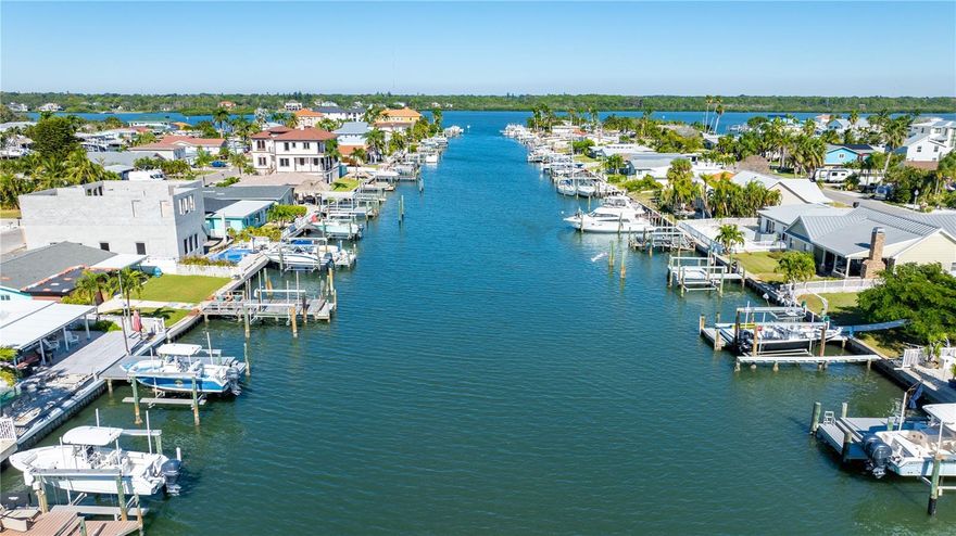 Experience the epitome of coastal luxury with this rare waterfront property, endless potential, ideally positioned at the end of a serene channel in the prestigious Redington Shores community. Offering unobstructed water views that only a handful of homes in this channel can claim, this is truly a rare opportunity to own one of the most desirable pieces of property on the barrier islands. Boasting 50 feet of private water frontage, newly installed limestone rip rap (2025), and a heavy-duty dock built from weather-resistant composite decking, this lot perfectly blends natural beauty with refined coastal design potential. The 90’ x 50’ lot is ready for its next chapter; whether you choose to elevate and restore the existing structure or build a brand-new coastal masterpiece from the ground up, the possibilities are limitless. Inside, the existing home showcases impressive craftsmanship, tall vaulted ceilings, and striking exposed wood beams that immediately capture the eye and hint at the home’s architectural potential. With the right vision, this residence can be transformed into an extraordinary showpiece that honors its character while embracing modern luxury. Enjoy peaceful mornings watching dolphins, manatees, and coastal birds glide through the channel right from your backyard. Just minutes away, you’ll find direct beach access, a short walk across Gulf Blvd. and a dedicated grassy area for dogs, perfect for morning strolls. The location is unbeatable, close to John’s Pass Village and Indian Rocks Beach, where fine dining, boutique shopping, and coastal recreation await. Additional highlights include a swivel lift for a small boat or jet ski (electrical box replacement needed) and a multi-zone underground irrigation system (buyer to verify it is operating during inspection period) connected to reclaimed city water. This property is more than a home, it’s an opportunity to create your own waterfront sanctuary, combining timeless craftsmanship, tranquil beauty, and the luxury of true island life.