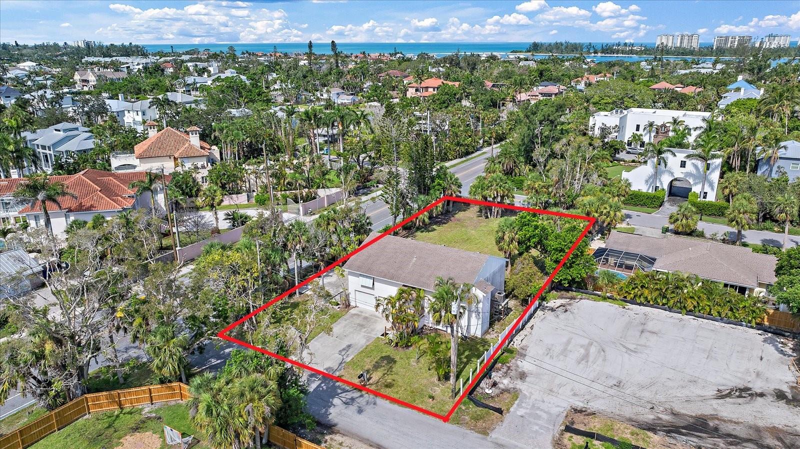 Under contract-accepting backup offers. Exceptional redevelopment opportunity in Bay Isles on Siesta Key—where short-term rentals are permitted! The current home experienced water intrusion and damage during recent storms. This property is being sold for land value only. This generously sized parcel is two lots totaling 16,200 square feet (.37 acres), 90 ft of frontage and 181 feet deep. The lot spans the entire block from Anglin Dr to Flamingo Dr along Siesta Dr. No other residence backs up to it. This offering is an ideal canvas for a sizable custom home, pool, and pool-home. Whether you're a builder looking to create a luxury island residence or an investor eyeing short-term rental potential, this location delivers. In a quiet, established neighborhood, just a short distance from Siesta Key Beach and Siesta Village. Easy access to the mainland via the north bridge. A true strategic build site on Siesta Key.