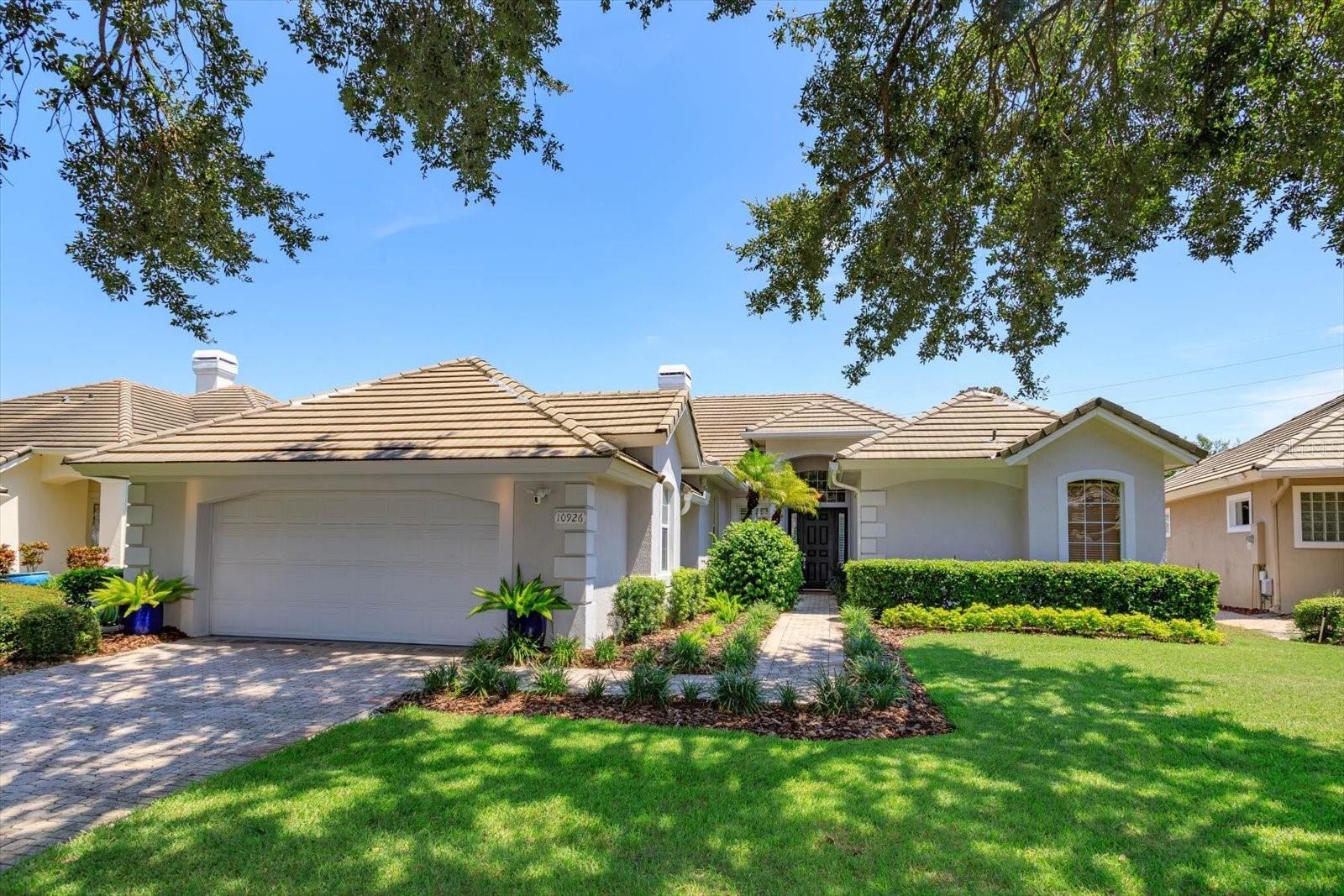 Enjoy the Central Florida lifestyle in this elegant home located in the guard-gated community of Avalon at Turtle Creek. Excellent curb appeal and professionally landscaped grounds highlight this premium lot. This home features an open floor plan with 3 bedrooms/3 bathrooms, formal dining room, living room and family room. Highlighted by neutral paint tones, plantation shutters, 5” baseboards, wood & tile floors and plenty of natural light throughout. The living room features a fireplace and French doors overlooking the pool. The kitchen is ideal for the aspiring chef in your family - featuring 42" light maple cabinets, solid surface counters, stainless steel appliances, an island and adjacent breakfast nook. The primary bedroom retreat is spacious and features a spa-like master bath and two walk-in custom closets. The second bedroom features an ensuite bathroom and walk-in closet. Extend your living area outdoors with a covered and screened lanai for enjoying the heated pool and spa year round. The back yard is private with lush landscaping – no rear neighbors. Upgrades include: EV charging station in garage, newer appliances, re-surfaced pool and exterior paint. Community amenities: clubhouse, community pool, park, playground, tennis, basketball and volleyball courts. Front yard lawn maintenance provided by HOA. Conveniently located to upscale shopping and dining at Restaurant Row, theme parks: Disney World, Universal, Sea World, medical and major roads. You will not want to miss seeing this meticulously maintained home!