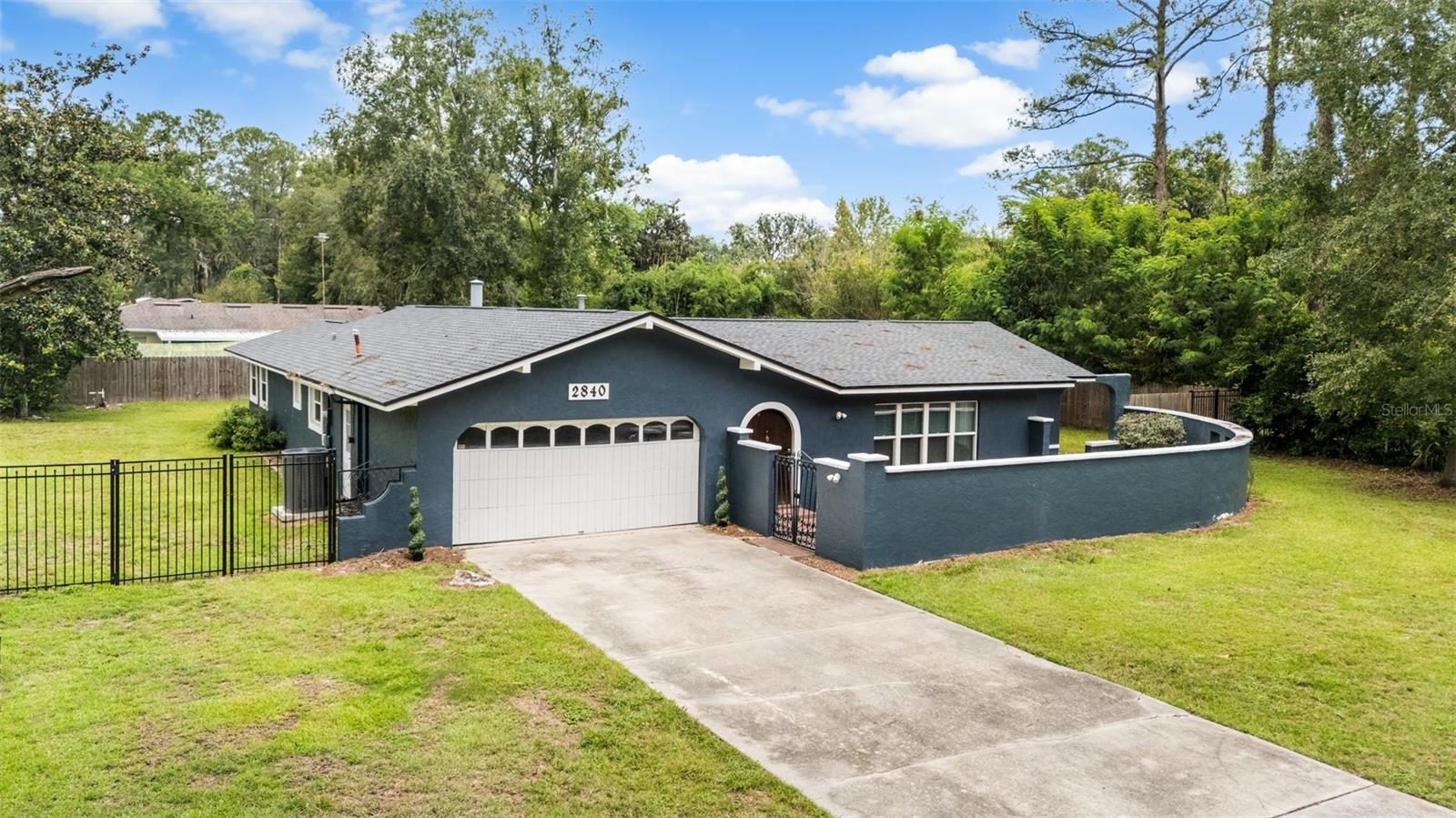 Forget those cookie cutter homes with no outdoor space. Come home to your very own castle. Check out this Concrete Block home with a beautiful enclosed pool in NW Gainesville. Enjoy the majestic oaks as you turn into the neighborhood. Drive into your extra long driveway to your 2 car garage and peek around the corner to find your own private courtyard. Imagine what you can do with this space! Enter the rounded, castle-like door into a giant living room with tall ceilings, the first of two large living areas. Past the living room, you'll find a breakfast nook and a completely remodeled kitchen. Enjoy new cabinets, new granite countertops, and tons of cabinet space with slow close drawers. Even a comfortable pantry for those fancy feasts! On this side of the house you’ll also find the master suite with updated tile shower and vanity and walk in closet. On the other side of the house, check out your formal dining room space, the wood fireplace in the family room (with a designated bar area), two more bedrooms, and a full bathroom. That third bedroom also has private access to the pool. In fact you can see the pool from most of the house. Four sets of french doors and large windows throughout the house offer tons of natural light without any neighbors peeking in. Outside you will find a covered patio with plenty of room for your outdoor furniture, and a screened in pool that has been resurfaced. Beyond that enjoy a wonderful fenced in yard that you can do as little or as much as you'd like with. And location? This home is right in the middle of town. You are less than 20 minutes from UF/ UF Health Shands, Santa Fe College, or North FL HCA Hospital. Best of all, you have a solid home with so many updates including a New Roof in 2018. In the past 5 years, the current owners have updated to a New Kitchen, New Master Bathroom, New Flooring, New AC, New Water Heater, New Interior and Exterior Paint, Re-Screened the enclosure, and had the Pool resurfaced. A pool home with character, very spacious and updated at a reasonable price? What else can one ask for?