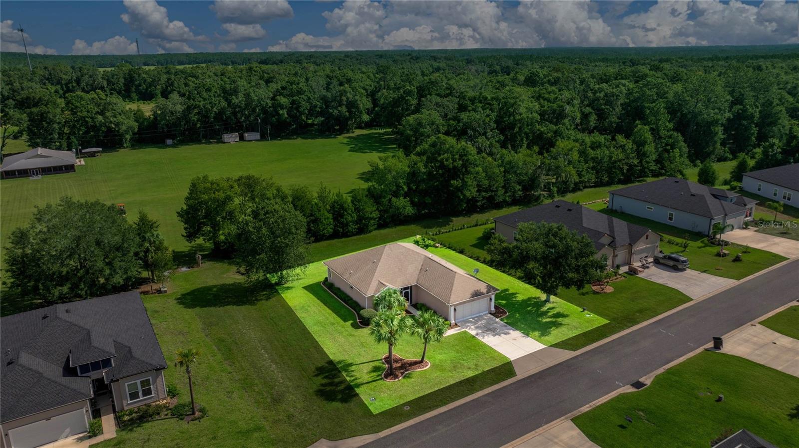 Fall in love with this beautifully maintained 3-bedroom, 2-bathroom home in the highly desirable Grand Park North community, where you’ll enjoy the rare perk of private beach access to the crystal-clear Rainbow River! Sitting on a spacious .30-acre lot and offering just under 1,700 sq. ft. of comfortable living space, this home combines modern updates with timeless appeal. From the moment you arrive, you’ll notice the impeccable curb appeal—professionally landscaped with lush greenery, decorative pavers, and a welcoming screened front entry. Step inside to find fresh interior paint, all-new laminate flooring, and stylish new light fixtures that create a bright, airy, and inviting atmosphere. The kitchen features a brand-new stainless steel appliance suite that will delight the home chef, while the washer and dryer are conveniently included for your move-in ease. The floor plan offers a formal dining room just off the kitchen, perfect for gatherings, and a light-filled primary suite with sliding glass doors leading to the rear screened porch. The oversized primary shower adds a touch of luxury, while the serene backyard—with no rear neighbors and peaceful church property behind—ensures privacy and tranquility. Additional features include a 2022 AC unit for year-round comfort and screened enclosures at both the front and rear of the home, perfect for enjoying Florida’s beautiful weather. Located in a no flood zone, this home is not only charming but also practical. Whether you’re relaxing at home or heading to the community’s private beach area on the Rainbow River, you’ll enjoy the very best of Florida living!