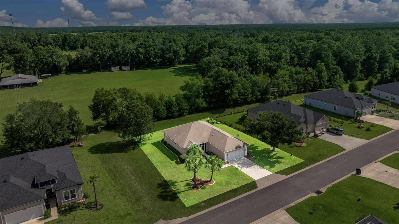 Fall in love with this beautifully maintained 3-bedroom, 2-bathroom home in the highly desirable Grand Park North community, where you’ll enjoy the rare perk of private beach access to the crystal-clear Rainbow River! Sitting on a spacious .30-acre lot and offering just under 1,700 sq. ft. of comfortable living space, this home combines modern updates with timeless appeal. From the moment you arrive, you’ll notice the impeccable curb appeal—professionally landscaped with lush greenery, decorative pavers, and a welcoming screened front entry. Step inside to find fresh interior paint, all-new laminate flooring, and stylish new light fixtures that create a bright, airy, and inviting atmosphere. The kitchen features a brand-new stainless steel appliance suite that will delight the home chef, while the washer and dryer are conveniently included for your move-in ease. The floor plan offers a formal dining room just off the kitchen, perfect for gatherings, and a light-filled primary suite with sliding glass doors leading to the rear screened porch. The oversized primary shower adds a touch of luxury, while the serene backyard—with no rear neighbors and peaceful church property behind—ensures privacy and tranquility. Additional features include a 2022 AC unit for year-round comfort and screened enclosures at both the front and rear of the home, perfect for enjoying Florida’s beautiful weather. Located in a no flood zone, this home is not only charming but also practical. Whether you’re relaxing at home or heading to the community’s private beach area on the Rainbow River, you’ll enjoy the very best of Florida living!
