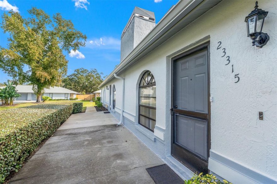 Welcome to Club Villas Condominiums—a beautifully maintained 2-bedroom, 2-bath home with an attached 1-car garage. The spacious living and dining area features vaulted ceilings and a charming stone, wood-burning fireplace. The large eat-in kitchen offers plenty of cabinet and counter space plus a pantry area. The primary suite includes dual sinks, a walk-in shower, and a generous walk-in closet. Impact-rated windows and doors, along with new roofs (July 2024) covered by the association, provide peace of mind. Enjoy a maintenance-free lifestyle with access to a clubhouse, pool, fitness center, tennis, racquetball, basketball, and shuffleboard courts, plus walking trails and a playground. Conveniently located near top restaurants, shopping, beaches, and theme parks—this condo is the perfect place to call home!