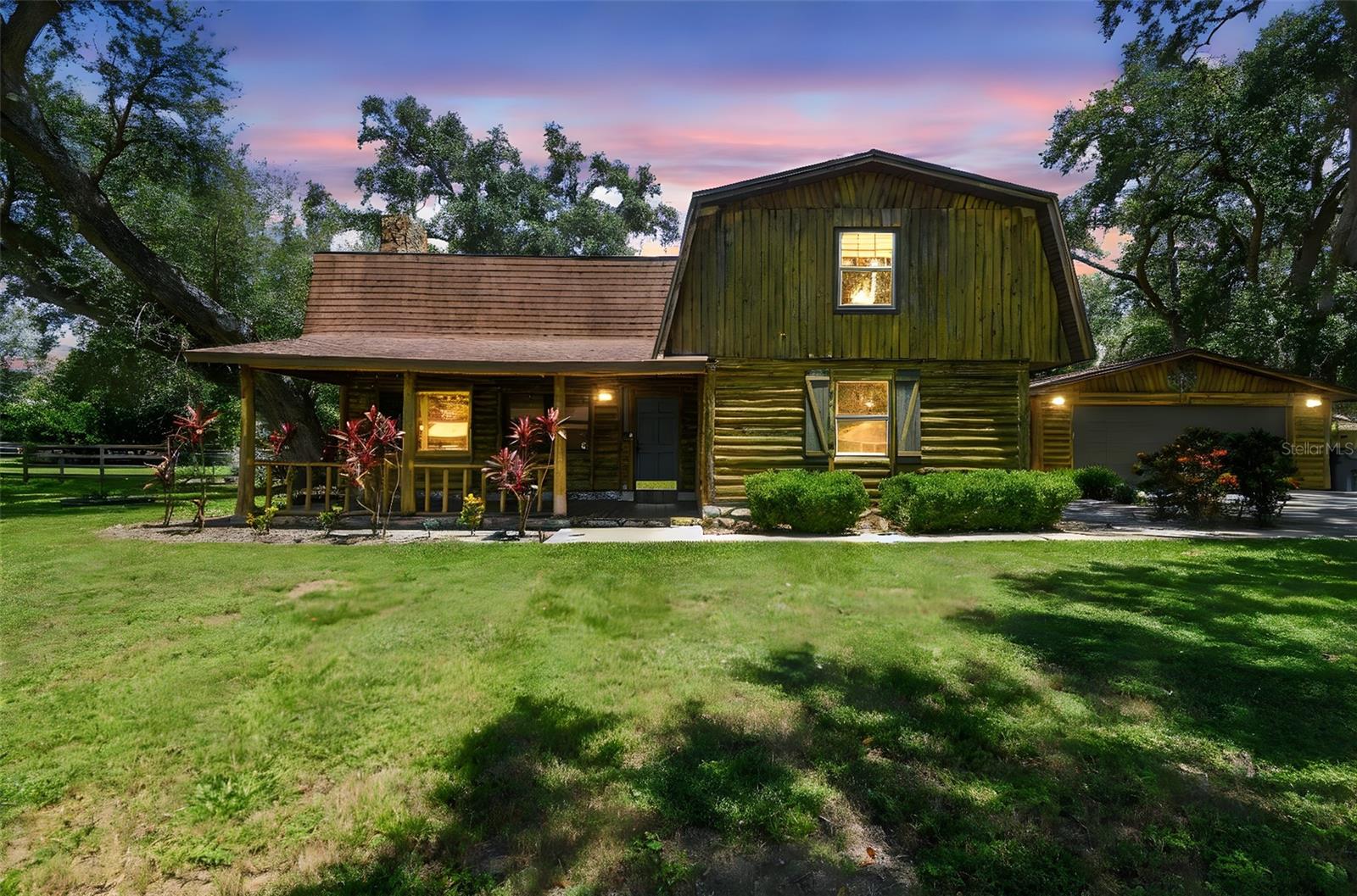 **No HOA – Bring Your Boat, RV, and Big Dreams!**
This move-in-ready, 3-bedroom, 2.5-bath authentic log cabin offers rustic charm with modern updates, including a new roof (2017) and HVAC system (2018). Nestled on a spacious 0.38-acre lot, the home features a fenced yard with double-gated access—perfect for storing your recreational vehicles. An expansive front porch welcomes you into nearly 2,600 sq ft of living space, where a soaring vaulted ceiling and striking stone wood-burning fireplace create a warm, inviting great room. Overlooking the space is a 10x28 ft loft, ideal for relaxing or entertaining. The kitchen has been tastefully updated with solid wood cabinetry and refinished butcher block countertops, complemented by a large island/breakfast bar perfect for gathering. Just off the kitchen is a built-in storage area leading to a generous dining space with a pantry and access to the screened rear patio. The downstairs primary suite features a walk-in closet and an ensuite bath with dual sinks and dual shower heads. Upstairs, you'll find two oversized bedrooms with walk-in closets and a shared full bath with double vanities. A detached, oversized two-car garage includes indoor laundry and connects to the home via a covered breezeway. This unique property combines privacy, space, and flexibility—ready for your next adventure!