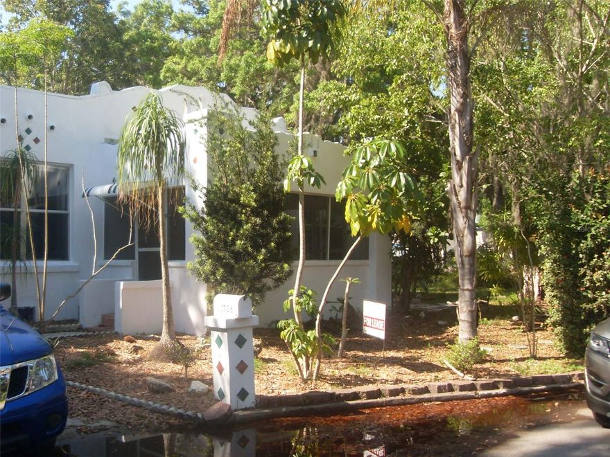2 bedroom, 1 bath house features 2 fireplaces, 1 in living room and 1 in primary bedroom! Lots of charm and character including hardwood floors! Kitchen has replaced cabinets and granite counters. Large fenced backyard and 2 car garage. This is the main house of a tri-plex. Close to Manatee Memorial Hospital.