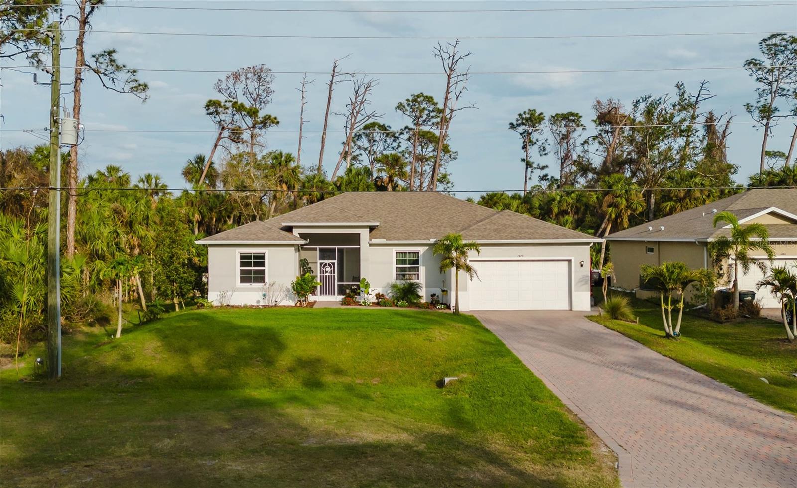 WOW!!! What a lovely 3 bedroom PLUS OFFICE/DEN house! CITY WATER! Owner occupied since it was built in 2021, this house has been VERY WELL MAINTAINED! Beautifully MODERN DESIGNED, this very cozy house makes you feel right at home! The house specifies a GORGEOUS KITCHEN with granite countertops, screened lanai and a large back yard to easily fit a future pool! Beautiful landscaping, fruit trees, driveway and sidewalks made of pavers and much more, just come and look! NOT IN A FLOOD ZONE. NO HOA. Close to schools, parks and public beaches, yet it's in a very nice and quiet neighborhood! Hurry to make it your home sweet home!!!