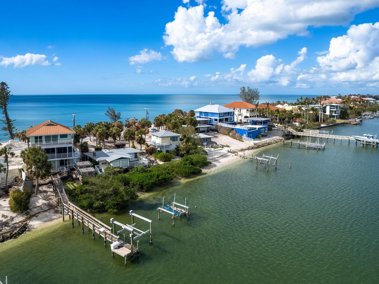 One or more photo(s) has been virtually staged. Welcome to Casey Key, your personal paradise! This home offers unparalleled waterfront living with views that stretch across the Gulf of America and Little Sarasota Bay. From the great room and elevated primary suite, you can enjoy sunrise vistas over the tranquil bay and breathtaking sunsets over the gulf. The design of this home is an ideal blend of coastal simplicity and charm, with aluminum railings that seamlessly connect the interior with expansive outdoor spaces. Key features include hurricane rated impact windows and doors, metal roof, full home generator, elevator, dock and 12,000 lb lift. Whether you're looking to relax, entertain or indulge in your love for boating, this property has it all. The deep-water dock offers direct access to the bay, making it an ideal spot for boating enthusiasts. Plus, with an eight-mile stretch of pristine beach right at your doorstep, you’ll have endless opportunities for beach visits, sunbathing or enjoying the serene sounds of the water. Offered as-is with right to inspect, this property is a rare opportunity to own a one-of-a-kind residence on one of Florida’s desired barrier islands. Don't miss the chance to make this incredible waterfront home your own.