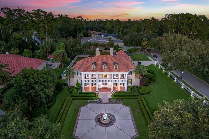 Alaqua - Custom J.C. Brown masterpiece nestled on an acre homesite in Seminole County's premier, guard-gated luxury neighborhood.  This truly one-of-a-kind property boasts a myriad of updates, upgrades, and a jaw-dropping elevation with its 5 bedrooms, 6 full and 2 half bathrooms, home office, and GUEST HOUSE/casita.  Arrive home enveloped in a custom wrought iron and custom pillar fence, and be amazed upon entry through double doors.  Guests are treated to soaring ceilings in the grand foyer set the tone for a truly luxurious experience.  An open and airy floorplan with an abundance of natural light is immediately appreciated, while exotic marble flooring underscores the ultra-high level of finish and craftsmanship throughout.  The kitchen is worthy of a Michelin star, with Wolf cooktop, ovens(2), warming drawer, Miele full-size refrigerator and freezer, Miele built-in coffee/espresso machine, dual dishwashers, and a walk-in pantry with incredible built-in storage and ice machine.  The downstairs master suite is truly a destination unto itself with its spa-quality bath and enormous walk-in closet.  Upstairs, one finds 4 oversized bedrooms all with renovated ensuite bathrooms.  An expansive covered lanai area overlooks a sparkling pool; the Florida lifestyle is truly enjoyed with a summer kitchen/bar area, as well as an elevated dining/lounge area with pergola.  Guests needing extra privacy are welcomed to the guest house/casita with its own bathroom, and copious space to relax.  Have peace of mind with big ticket items already replaced - ceramic tile roof(replaced/re-pitched 2010), plumbing(replaced 2010), nearly all windows(2010), and much more.  Your private retreat awaits; all with the conveniences of world-class golf, shopping, restaurants, schools, business parks, and highways nearby. I4  This property may be under audio/visual surveillance.