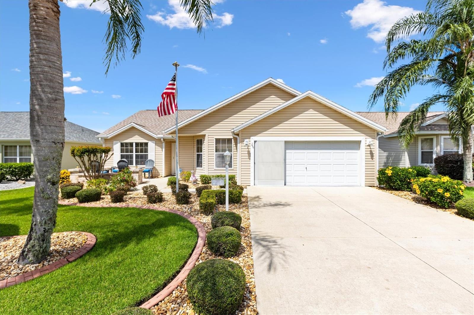 Lovely 3/2 Wisteria Designer Home in The Village of Sabal Chase. NO Bond! Roof 2025, HVAC 2015, Gas HWH 2024. And just 1.4 miles to Lake Sumter Landing. This home features an updated front paver patio with a brick wall, low-maintenance rock bedding, and a covered entry with Phantom screen door. A stained-glass side panel adds an elegant touch as you step inside.
The eat-in kitchen is designed for both style and function, showcasing stainless steel appliances, a 4-burner gas stove, granite countertops, pull-out cabinet shelves and pantry. The breakfast bar opens the kitchen to the rest of the living space.
This split-bedroom floor plan offers privacy and comfort, with crown molding, ceiling fans and new carpeting. 2 solar tubes fill the home with natural light. The master suite features a large walk-in closet and a ensuite bath with a Roman walk-in shower and dual vanity. The Guest bedrooms share a bath with tub shower combo.
Relax year-round in the enclosed lanai, or step outside to the canopy-covered, screened birdcage—perfect for relaxing or entertaining guests.
The 2 car garage is designed for practicality and comfort including an attic stair kit and built-in storage cabinets and workbench. The Wall unit in the living room, 2 TVs and the reclining sofa in the lanai convey with the home. Just minutes to Bacall and Canal Street Recreation Center and Largo and Sabal Chase Pools, and between Lake Sumter Landing and Brownwood Town Center, this is the perfect place to call home! Be sure to watch our virtual tour of this wonderful home and schedule your appointment to see it today so you can start living The Villages dream.
