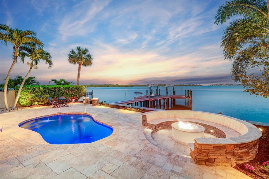 Waterfront Oasis with private dock in St. Petersburg, FL. Superior craftsmanship combined with elegance defines this custom-built 3 story home found on the tranquil waters of Tampa Bay. This home is elevated (high and dry) and built to last with its impressive exterior all block construction, hurricane impact resistant windows & doors, tile roof, substantial sea wall and whole house generator. It's brimming with architectural details and magnificent water views throughout. The impressive open concept "water view" kitchen is a gourmet chef's dream with a massive granite island, custom cabinetry, an abundance of storage and professional series appliances. The kitchen opens to the great room also with fabulous water views. The home features “smart automation technology”, maple wood floors, custom built-ins, a main level primary suite with large walk-in dressing room and luxurious en-suite bath, a nicely appointed guest suite, plus an executive office. The second living level consists of two bedrooms, a wet bar and large family room that opens to an enormous balcony with more amazing waters views. The third level has yet another family room, perfect for yoga or quiet reading and a balcony with more spectacular views of open Tampa Bay and downtown St Petersburg. Entertain in grand style by utilizing accordion doors that open to seamlessly blend indoor and outdoor living. The private back yard features a large covered terrace, inviting fireplace, outdoor kitchen, and built in fire pit that surround the Pebble-Tec salt water pool. The “U” shaped custom dock with boat lift can accommodate a large vessel making boating or fishing a breeze. This home offers expansive views of Weedon Island Preserve, a protected 3,190 acre coastal ecosystem that can be accessed in 5 minutes by kayak or paddle board.  This home has something for everyone and is conveniently located just a short bike ride to Vibrant downtown St Petersburg and is only a 20 minute drive to Tampa International Airport.