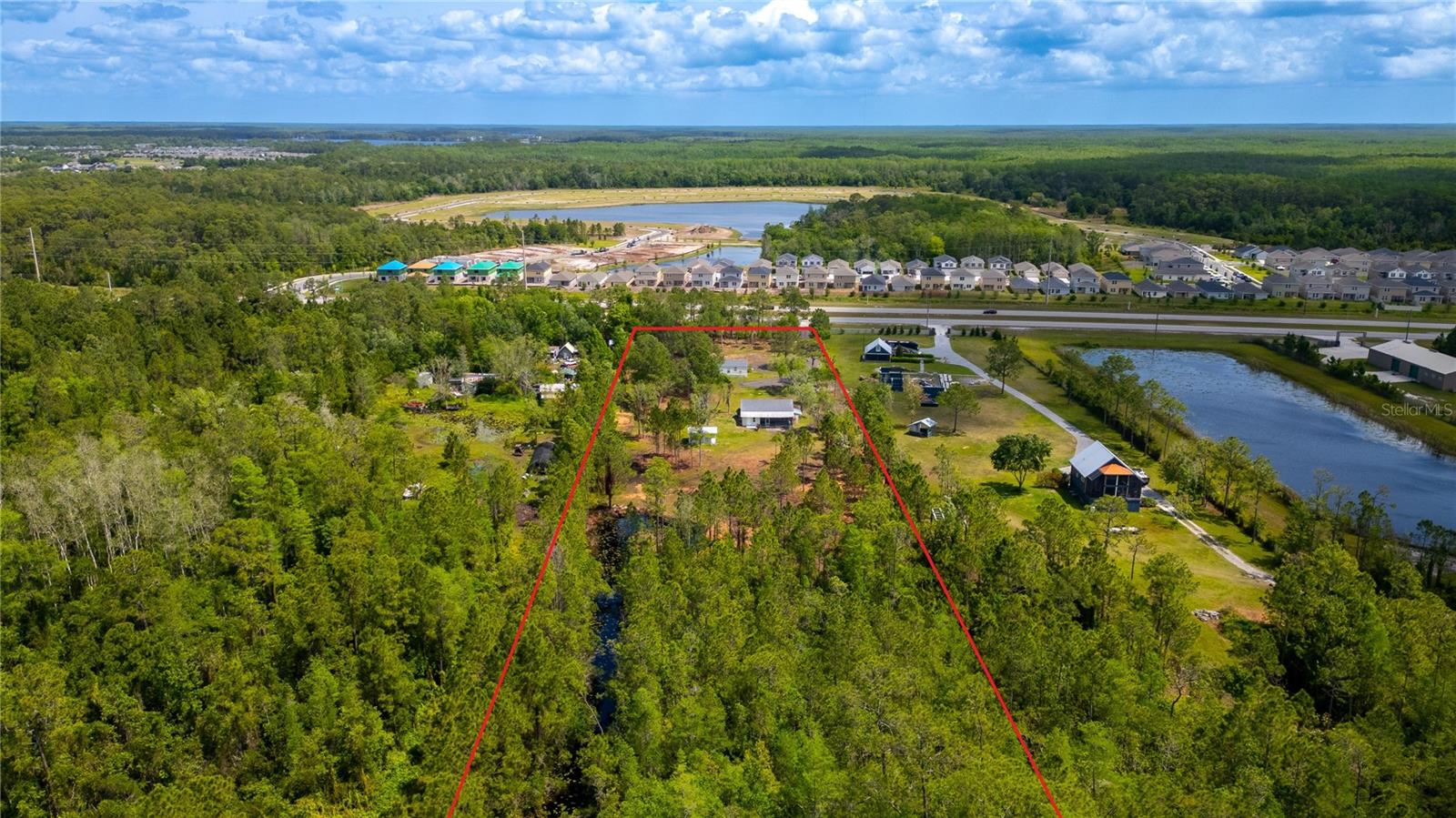 6.88-acre lot now available, with potential development opportunity located at 7450 E Irlo Bronson Memorial Highway, Saint Cloud, FL 34771. Positioned along one of Central Florida’s most traveled corridors, this site offers exceptional visibility, accessibility, and long-term growth potential.
The property currently features two residences: a 1,168 square foot single-family home built in 1995 and a 1,056 square foot mobile home built in 2004. These existing improvements provide immediate utility or interim rental income while planning future development.
Zoned AC, the site offers flexibility for a variety of commercial and residential uses. Strategically located in fast-growing Osceola County, the property benefits from strong demographics, rapid nearby residential expansion, and excellent connectivity to Orlando, Lake Nona, and downtown Saint Cloud. With its large parcel size and ample frontage along Irlo Bronson Memorial Highway, the site captures substantial daily traffic exposure.