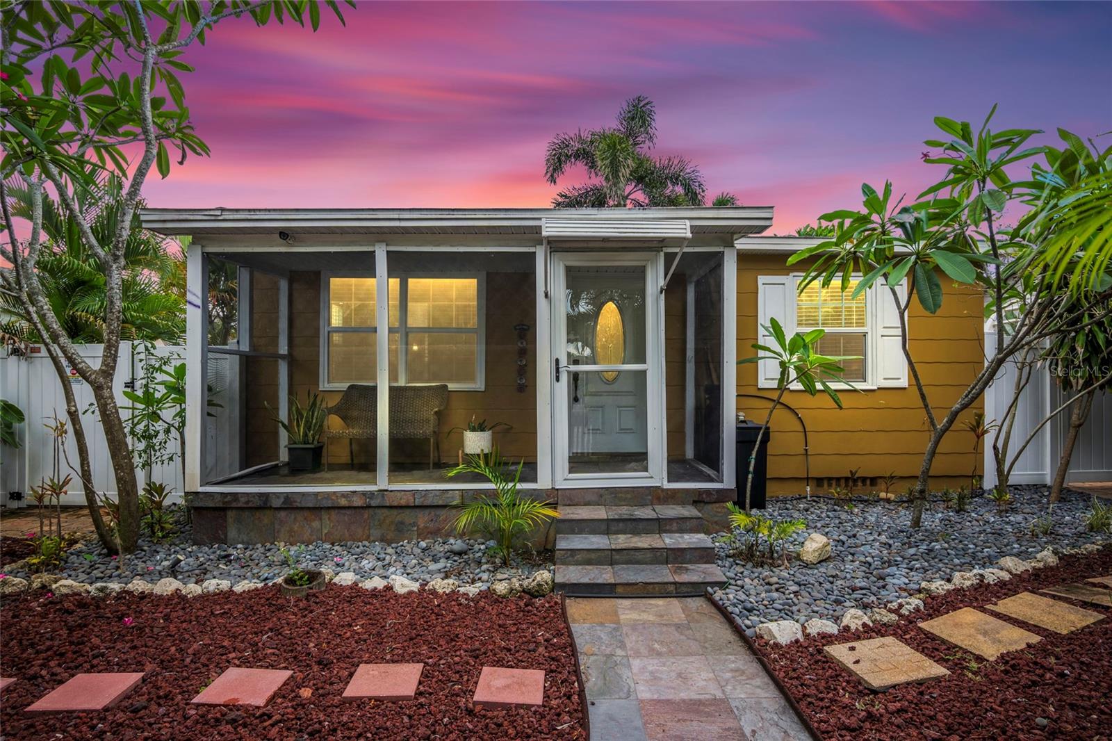 Tropical Paradise with Resort-Style Living !
Welcome to your private retreat in the heart of Saint Petersburg. This beautifully updated 2-bedroom, 1-bath home blends modern convenience with true Florida living. Surrounded by lush landscaping—including pineapples growing right in your backyard—this property was designed for both relaxation and entertaining.
Enjoy a private screened front porch, unwind in the covered jacuzzi, or host gatherings under the gazebos, around the brick firepit, or at the outdoor grilling station. As night falls, the professional landscape lighting transforms the backyard into a breathtaking resort-style escape.
Inside, you’ll find stainless steel appliances, granite countertops, wood cabinetry, a custom river rock backsplash, and no carpet throughout. The spa-inspired bathroom boasts a glass walk-in shower with a river rock floor. Additional features include an updated electrical panel, water softener, washer/dryer hookups in the attached garage, full vinyl fencing with three gates, and alley access with a paved parking pad.
All of this is located just minutes from award-winning Gulf beaches, top restaurants, and the vibrant lifestyle of downtown St. Pete. Whether you’re searching for a year-round residence or a Florida retreat, this move-in-ready home is a rare find in a prime location.