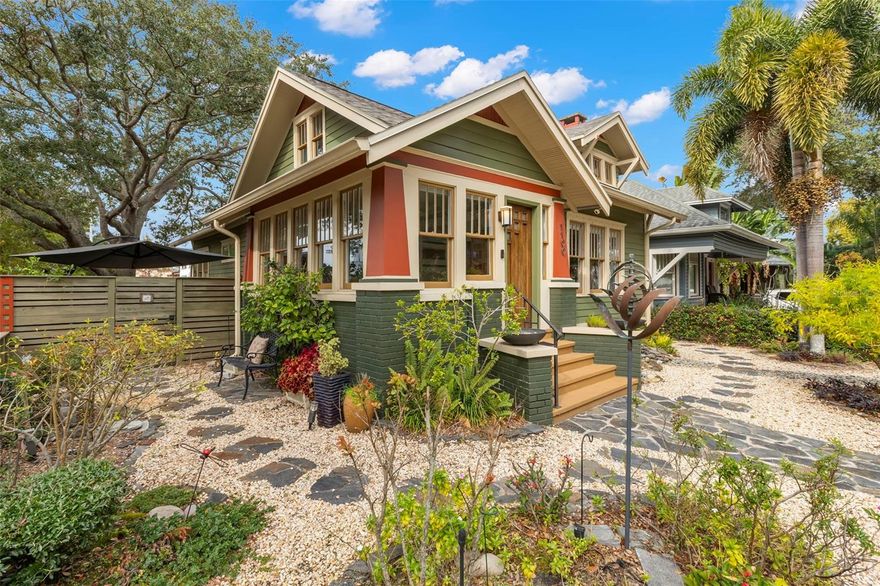 Charming 1925 Craftsman bungalow situated on a corner lot just steps to 4th Street and downtown! This 2 bed/2 full bath, 1359 sq/ft home has been lovingly restored with recent updates to include a new roof, A/C and interior painting in 2025. The fenced exterior with lush landscaping and botanical gardens features multiple sitting areas with pavers and stones to create the perfect sanctuary for entertaining or relaxation! The exterior paint color is true to the era of the home and a well appointed nod to the 1920's. Greet your guests in the welcoming sunny sitting room and home office with lots of natural light. Continue on in the living room, which has a beautiful original fireplace with built-ins that opens to the dining room and kitchen for casual entertaining. The kitchen boasts stainless steel appliances featuring a gas range, granite countertops, custom cabinets and a built-in desk nook. The primary bedroom is spacious with highlights to include a large walk-in closet, an updated bathroom with marble flooring/vanity and walk-in shower. The second bedroom features a murphy bed/desk combo with a hall bath that has also been updated with new flooring and modern glass shower doors. Plenty of off street parking in the detached garage or on the parking pad behind for 2 cars.  Additional garage features include lots of storage cabinets, attic with cargo lift, epoxy floors, a wall unit to heat and cool should someone desire an art studio, gym or home office. Other features include Brazilian cherry hardwood floors, 5 panel solid craftsman doors, 9 ' ceilings, crown molding, inside laundry, sprinkler system on a private well, security cameras and a gas/tankless water heater. Located outside the flood zone you will be sure to have peace of mind when storms approach.  Schedule a private showing today to see one of Old Northeast charming bungalows!