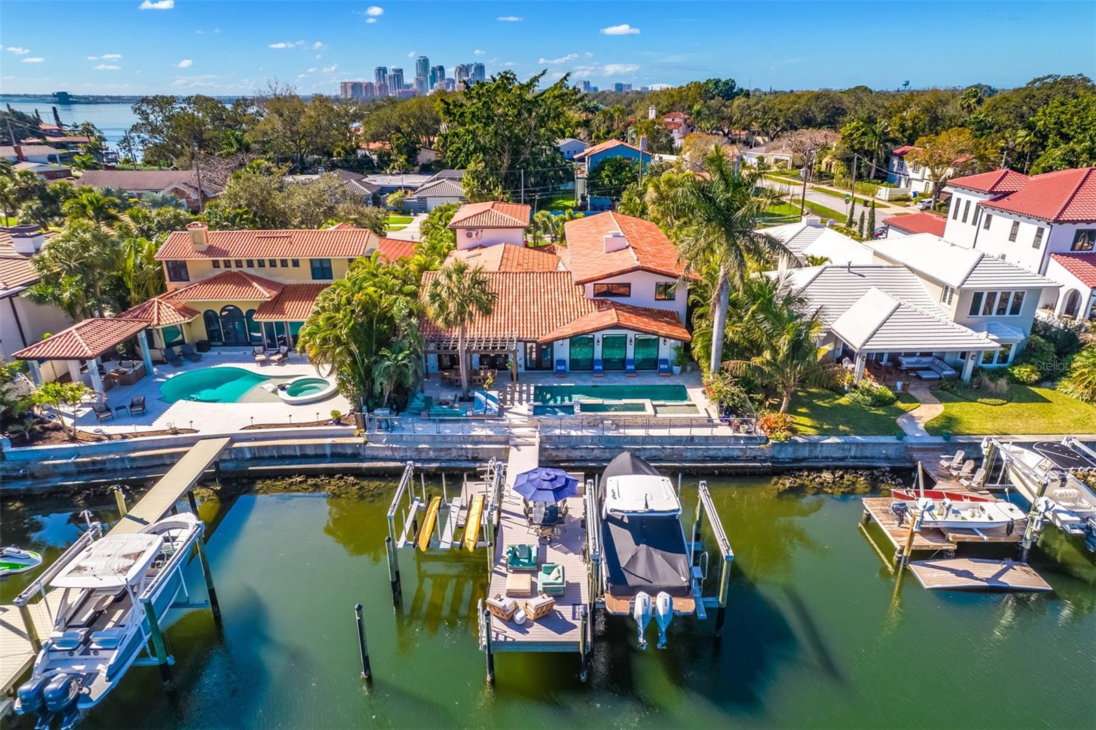 Rare Opportunity on Snell Isle – A Waterfront Gem in Northeast St. Petersburg
Don’t miss this exceptional investment opportunity – the lowest priced home over 4,000 sq ft on prestigious Brightwaters Boulevard.. Recently remodeled and truly move-in ready, this stunning waterfront residence offers unmatched value. For boaters, this is a dream location with no bridges to limit boat size—a rare find, especially considering the next comparable home is nearly $1.5 million more. Designed for both boat and car enthusiasts, the property features a custom-built dock equipped with Neptune 24,000 lb and 10,000 lb lifts plus garage space for six vehicles, including a double car lift.
This 5,170 sq ft contemporary home offers 5 bedrooms, 5 full bathrooms, and a thoughtful first-floor living layout that’s handicap-friendly. Additional features include a dedicated home office, library, and sitting area. The beautifully landscaped front entry leads to a striking white marble foyer, filled with natural light and flowing seamlessly into the open living and dining areas overlooking the water—ideal for both entertaining and relaxing. There is a private solarium with a tranquil fountain that adds an extra layer of elegance. High-end finishes abound, including contoured ceilings, a wood-burning fireplace, LED lighting, and a full marble guest bath.
The chef’s kitchen features rare quartzite countertops, top-tier appliances, a mudroom, walk-in pantry, and a spacious casual dining bar. The luxurious main-level master suite is a serene retreat, complete with a custom-designed walk-in closet, built-in dressers, dual vanities, soaking tub, and rain shower. Upstairs, hardwood floors complement three additional bedrooms, two fully renovated bathrooms, barn doors, updated closets, and a cozy entertainment area. Peace of mind comes standard with hurricane-impact insulated windows and a natural gas Generac generator.
Step outside to a resort-style backyard featuring a waterfront pergola, triple waterfalls spilling into a dazzling pool and spa, outdoor shower, and a full pool bath outside with shower. The spacious dock is perfect for dining, lounging, or watching dolphins and manatees play in the protected deep water. Located on sought-after Brightwaters Blvd, this home offers quick access to Tampa Bay and the Gulf of Mexico. Hop in your golf cart and be in downtown St. Petersburg within minutes, enjoying top-tier dining, galleries, and museums. Just 25 minutes to Tampa International Airport, this is the perfect blend of luxury, location, and lifestyle.