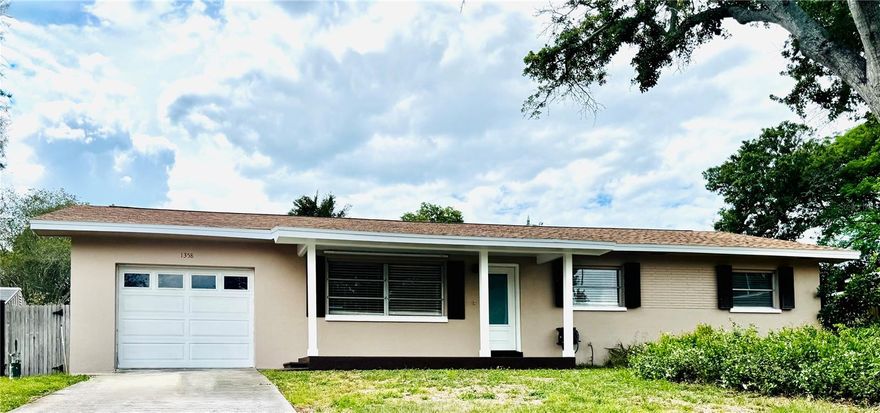 Welcome home to the best of Clearwater living in this beautifully refreshed mid-century modern home, where timeless character meets meaningful updates. From the moment you arrive, the freshly painted exterior creates a warm, inviting first impression that carries throughout. Inside, classic terrazzo floors ground the home in its original charm, while preserved vintage tile in the bathrooms adds a layer of character that’s both rare and desirable. Major updates including a new roof, HVAC system, sewer line, and a full suite of new appliances with natural gas, give peace of mind without compromising the home’s mid-century charm. At the heart of the home, the kitchen is where life naturally unfolds. Imagine morning light pouring in as coffee brews, the ease of preparing meals with new appliances, and evenings filled with conversation as cooking becomes part of the experience. The space flows effortlessly into the living area, where a cozy fireplace creates the perfect setting for quiet nights at home. Large windows frame a peaceful view of the backyard, blending indoor comfort with outdoor living. Designed for both function and ease, the home offers generous storage and a spacious laundry area that supports everyday living. Step outside to your private retreat, complete with a pool and a large fenced backyard, ideal for entertaining, relaxing, or simply enjoying Florida’s year-round sunshine. A rare opportunity to own a home that captures the essence of mid-century design while offering the updates today’s buyers expect. Located just minutes from Clearwater Beach and zoned for highly regarded schools, this property delivers convenience, lifestyle, and long-term value with the added benefit of no HOA.