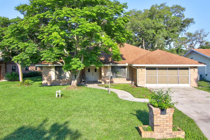 Located in a 24/7 guard-gated community, this home has a fabulous golf course view. You’ll appreciate the welcoming tiled foyer, the tiled dining room, the two-sided brick fireplace and the spacious Great Room with a wet bar and wine storage. Both the Great Room and eat-in kitchen open to a Florida room, adding 300 square feet of space for your enjoyment. Offering a coveted split-bedroom floor plan, there are vaulted ceilings, skylights, ceiling fans and a galley style kitchen with a breakfast nook. The private king-sized owner’s suite has two closets, a dual vanity, a walk-in shower and sliders to a small patio. A bedroom with French doors and a walk-in closet would be perfect for a den or office. The 2019 A/C, gas water heater, gas cook-top and the oversized garage are a bonus. This home is in Spruce Creek Fly In, a friendly community close to stores, restaurants, Port Orange area schools, recreation areas and it’s just a quick trip to the beach. Residents enjoy many amenities: private streets, a playground, parks, onsite management, 24-hour staffed gates and roving security, an onsite public restaurant, hair salon and other business services and an optional membership country club with pickleball, tennis, golf, exercise facilities and more. There is a private airport with a 4000' paved runway, paved taxiways, a GPS approach, VASI lights and aviation services including fuel. ;Water: City