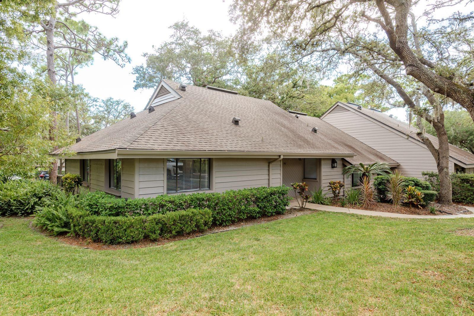 Beautifully Updated 2-Bedroom home in Peaceful Gleneagles, Palm Harbor.
Welcome to this charming end-unit, 2-bedroom, 2-bath, 1,258 sq ft home in the highly sought-after Gleneagles community of Palm Harbor. Perfectly situated in a non-flood zone and classified as a single-family home within a PUD, this residence offers both peace of mind and exceptional low-maintenance lifestyle. Step inside to discover an inviting living area featuring a beautiful stone, wood-burning fireplace, ideal for cozy Florida evenings. The split floor plan offers privacy, with the spacious primary suite boasting a walk-in closet, en suite bath with a double-sink vanity, and a glass enclosed shower/tub combo. The second bedroom is located on the opposite side of the home, with a full bath and sliding glass walk-in shower nearby. Enjoy your morning coffee or entertain friends on the large private patio, accessible from both the living room and the primary bedroom. Updates include new vinyl flooring throughout and a brand-new hot water heater. Practical features include a covered carport and a large storage unit. The HOA takes care of it all—cable, internet, water, sewer, trash, exterior pest control, landscaping, irrigation, roofs, siding, carport maintenance, and more—allowing you to truly enjoy the Florida lifestyle, worry free.
Located just off Belcher Road, you’ll be moments from top-rated schools, dining, shopping, golf, and the area’s beautiful beaches. Don’t miss this opportunity to own in one of Palm Harbor’s most peaceful and well-maintained communities. Call for a private showing today!