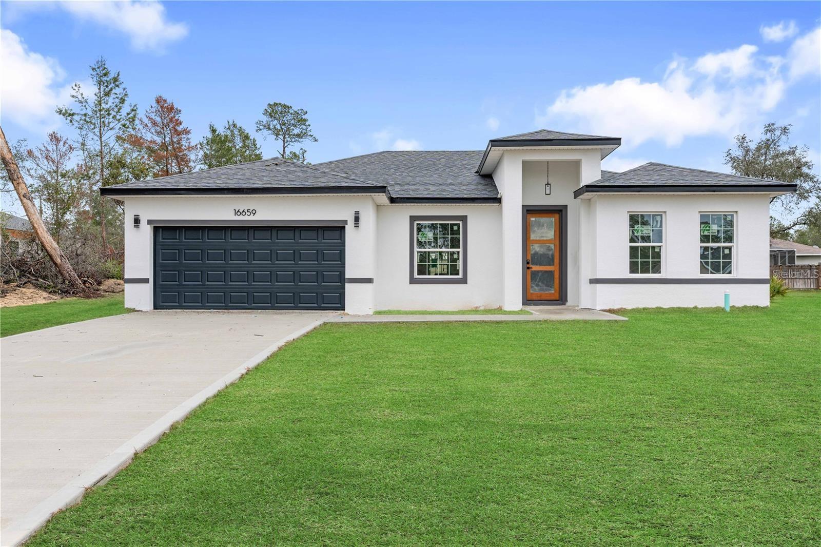 New, Modern Home in Ocala - Comfort, Style, and Convenience! This stunning, newly built home in Ocala is designed to offer
maximum comfort and style for your family. It features four spacious bedrooms, all equipped with custom closets that ensure excellent organization and
convenience. The home features two well-finished bathrooms, both with high-quality cabinets, bringing sophistication and functionality. Upon entering,
you'll be greeted by an open floor plan that seamlessly integrates the living room, kitchen, and dining room, creating an airy and welcoming
environment. The kitchen, a true highlight, features quartz countertops, a central island, a spacious pantry, and also comes with cabinets and
appliances included, ideal for those who enjoy cooking and entertaining. The home also boasts a charming front porch and a small garden, providing
a pleasant space for leisure time. Sliding doors in the living room allow direct access to the outdoor area, adding more spaciousness
to the space. The two-car garage is practical, with
an automatic gate for added security and comfort. Don't miss the chance to live in the heart of Ocala in a home that
combines everything you and your family deserve. Schedule your visit today and imagine what it would be like to live in a place like this.